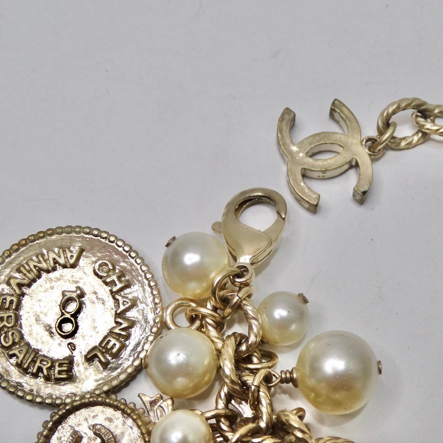 Do not miss out on this rare charm bracelet in celebration of Chanel's 100 year anniversary! Circa Spring/Summer 2014, this statement charm bracelet consists of a plethora of silver-plated metal charms mixed in with faux pearls. Notice how each