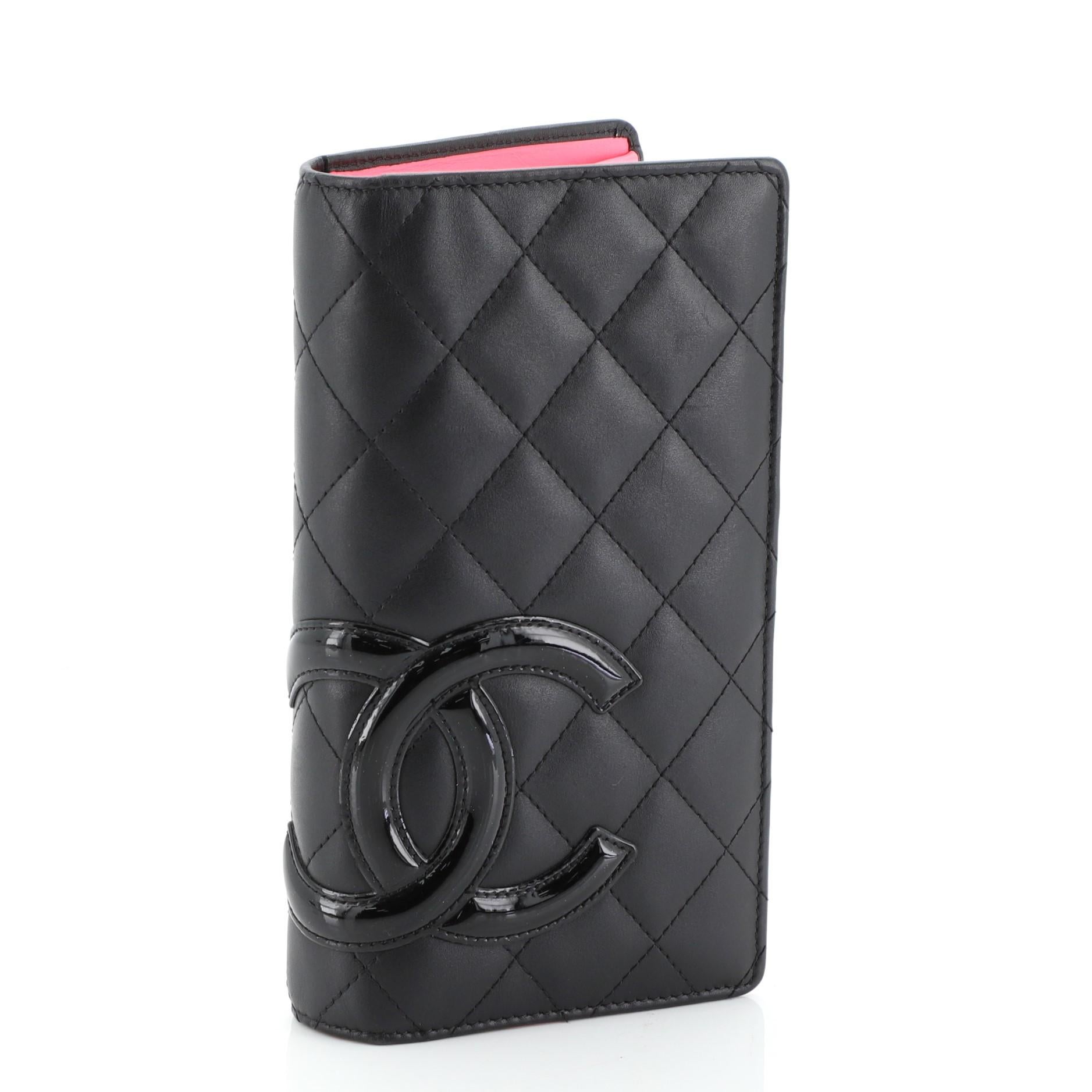 This Chanel Cambon Wallet Quilted Lambskin Long, crafted from black quilted lambskin leather, features patent CC logo and silver-tone hardware. It opens to a pink leather interior with multiple card slots, long flat pockets, and zip pocket. Hologram