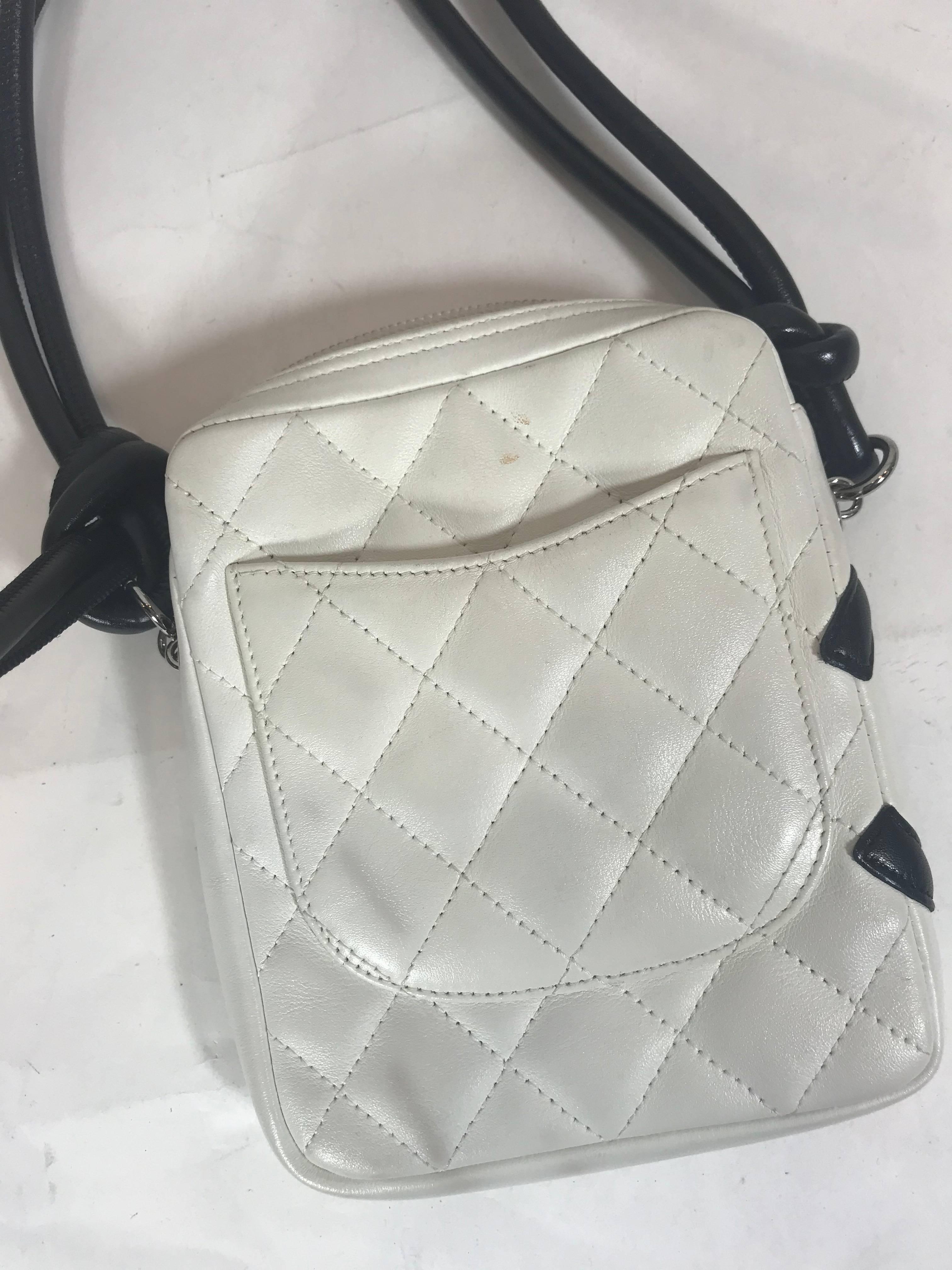 White and black cambon leather.
Silver-tone hardware.
Black crossbody strap.
One exterior opened pocket.
Bright pink interior lining with 