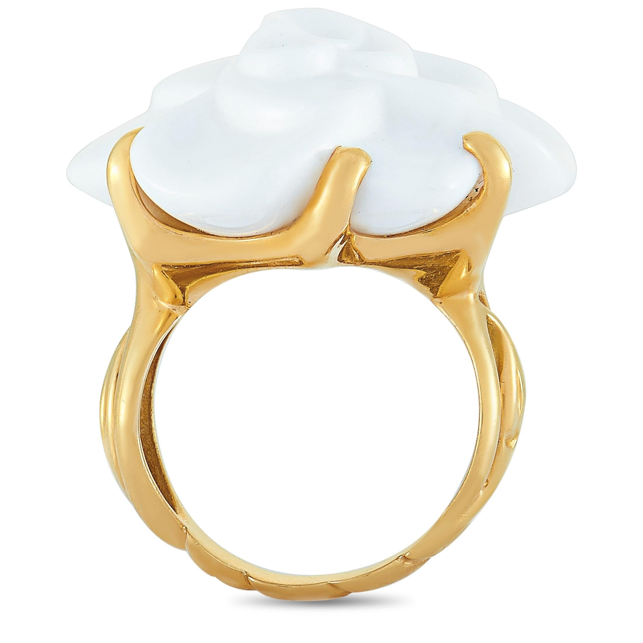 The Chanel “Camélia” ring is crafted from 18K yellow gold and boasts band thickness of 3 mm and top height of 12 mm, while top dimensions measure 26 by 23 mm. The ring is set with a white agate and weighs 22.3 grams.

This jewelry piece is offered