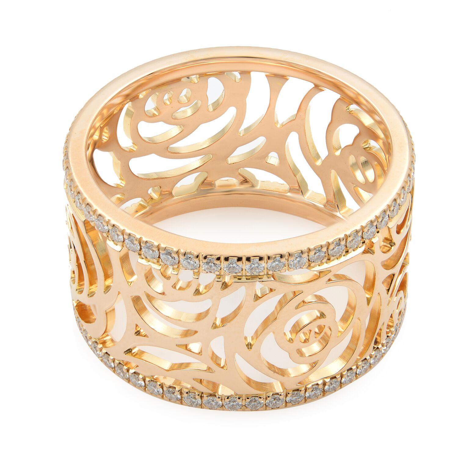 This is a Chanel Camelia ring in the larger version of this luminous band. Made in 18k rose gold with the brand's famous flower motif around the ring, this wide band is lined on top and bottom with a single row of brilliant cut diamonds. Diamond