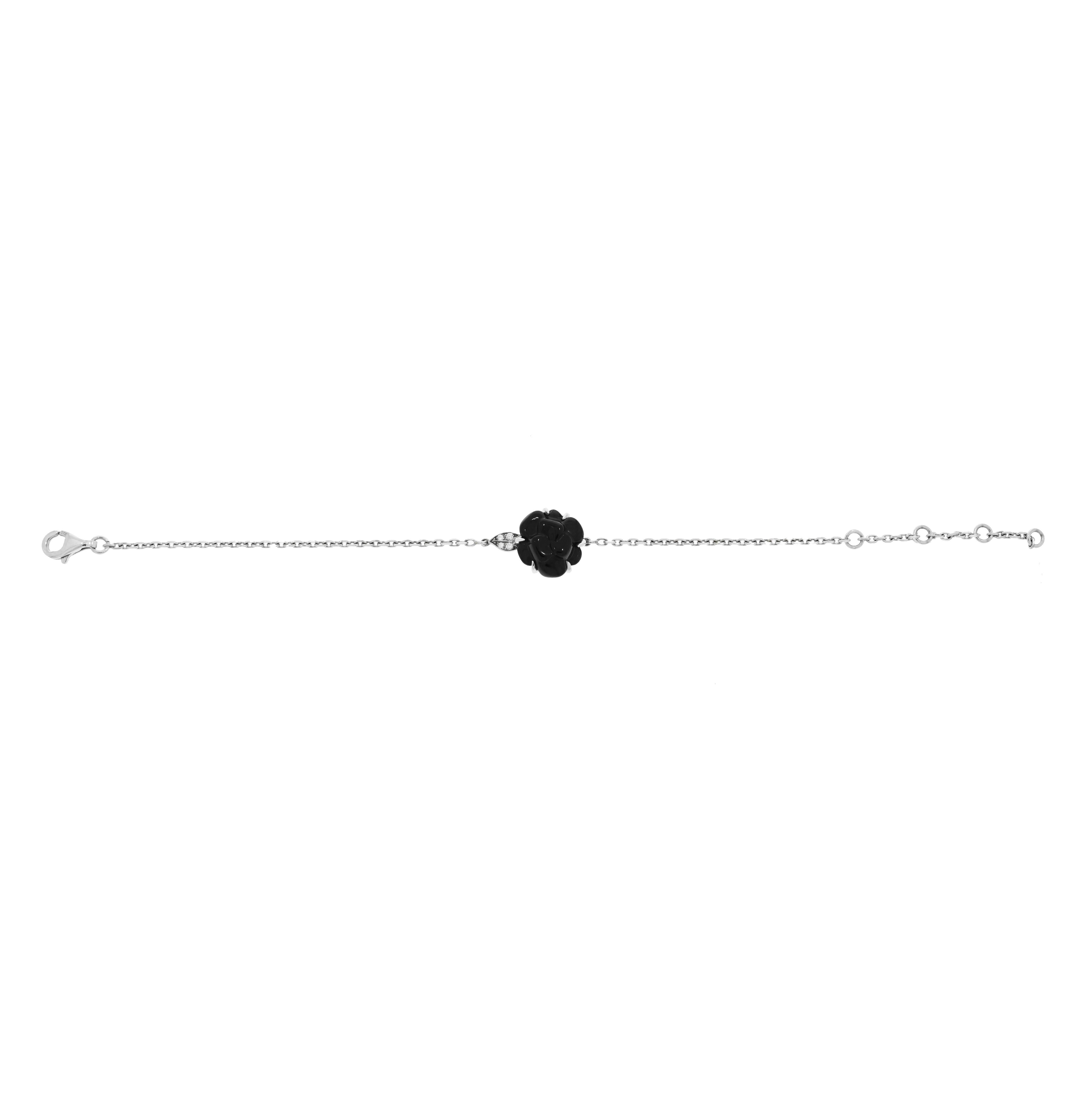 The classic Camélia Sculpté bracelet by Chanel.
Crafted in 18K white gold and a carved black onyx and accented with diamonds.