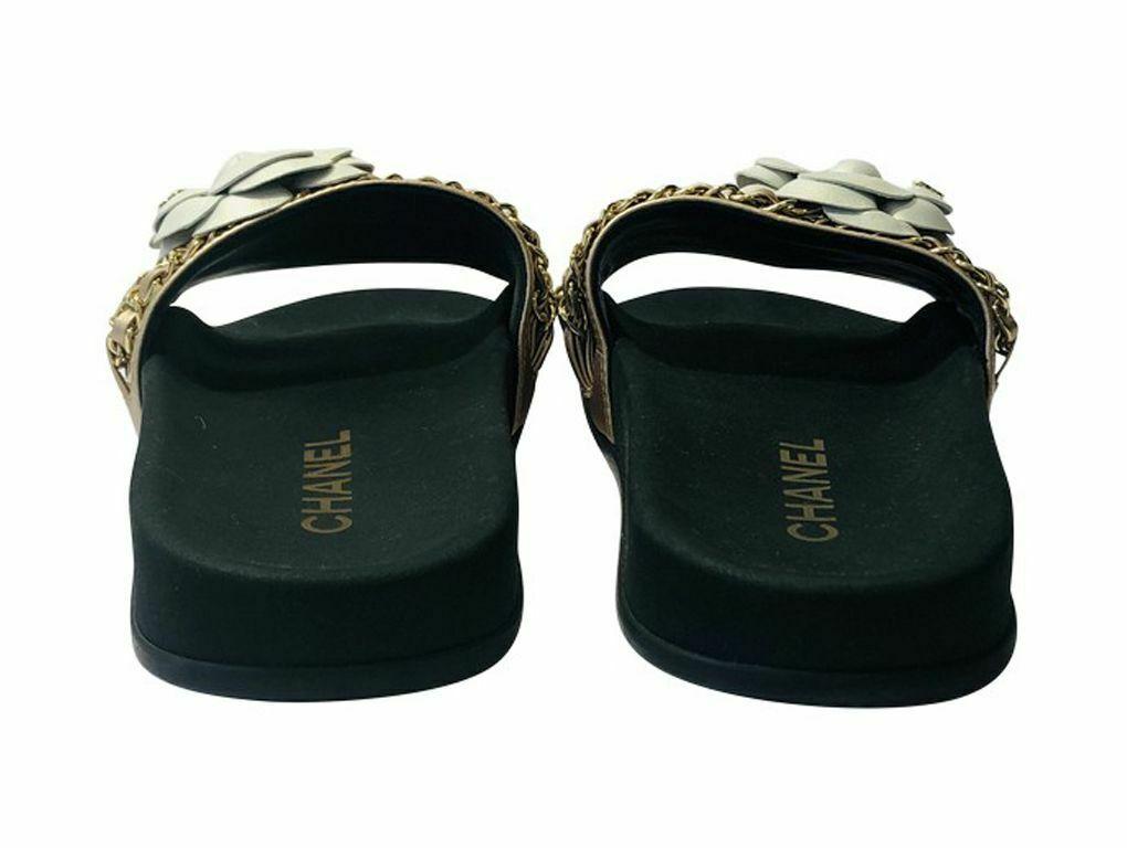 Stunning pair of Chanel Slides in a size 35 or UK 2 . An unused pair which were stored since purchase.


Chanel

FEATURES	
Camelia, Chain Detail

MATERIAL	
Leather

ACCESSORIES	
Box

HARDWARE	
Gold

CONDITION	
As new and unused

MEASUREMENTS	
35 (UK