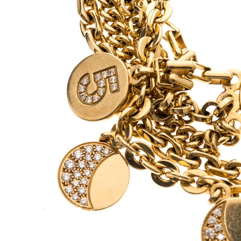 Perfect to adorn your delicate wrist and sure to garner your attention, this Chanel Camelia No 5 bracelet is a must buy! It is crafted from 18K yellow gold and features a collection of thick chains which are detailed with circular ring charms all