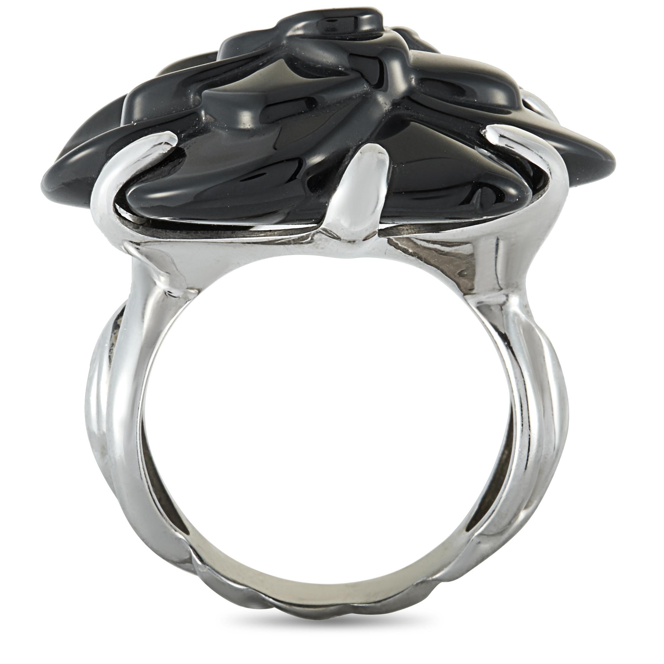 The Chanel “Camélia” ring is crafted from 18K white gold and set with an onyx. The ring weighs 11.9 grams, boasting band thickness of 4 mm and top height of 11 mm, while top dimensions measure 25 by 24 mm.

This jewelry piece is offered in estate