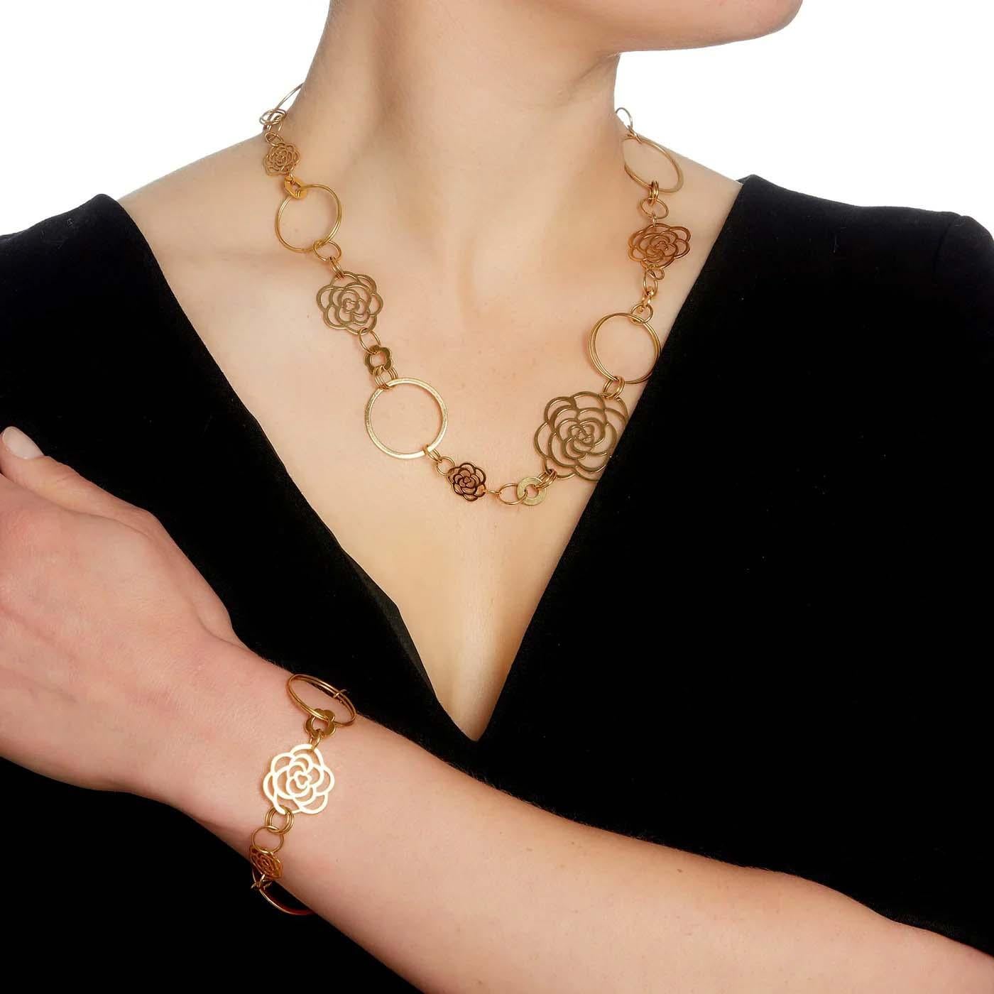 This chic authentic necklace and bracelet are by Chanel from the Camellia Collection. Crafted from 18k yellow gold with a polished finish. The necklace has small to large 7 camellia flower motifs with small to large circles and double ring motifs.