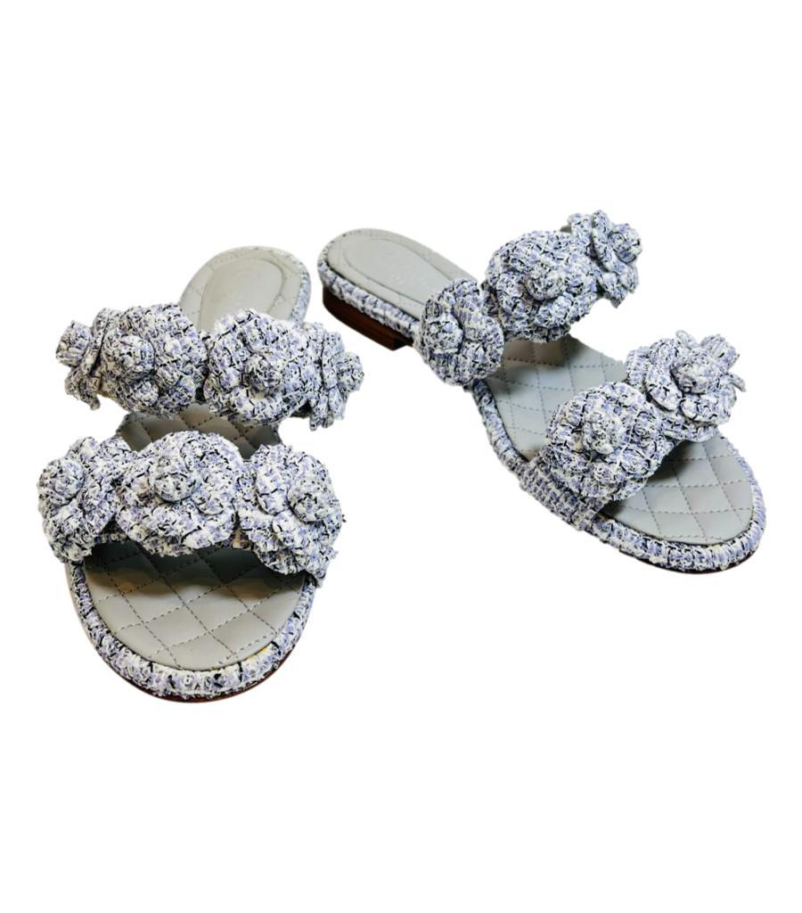 Chanel Camellia Flower Tweed Mules

Lavender sandals styled with Chanel's signature oversized Camelia flower decorated straps accented with silver 'CC' logo to the side.

Featuring leather insoles with iconic diamond stitching design and 'Chanel'