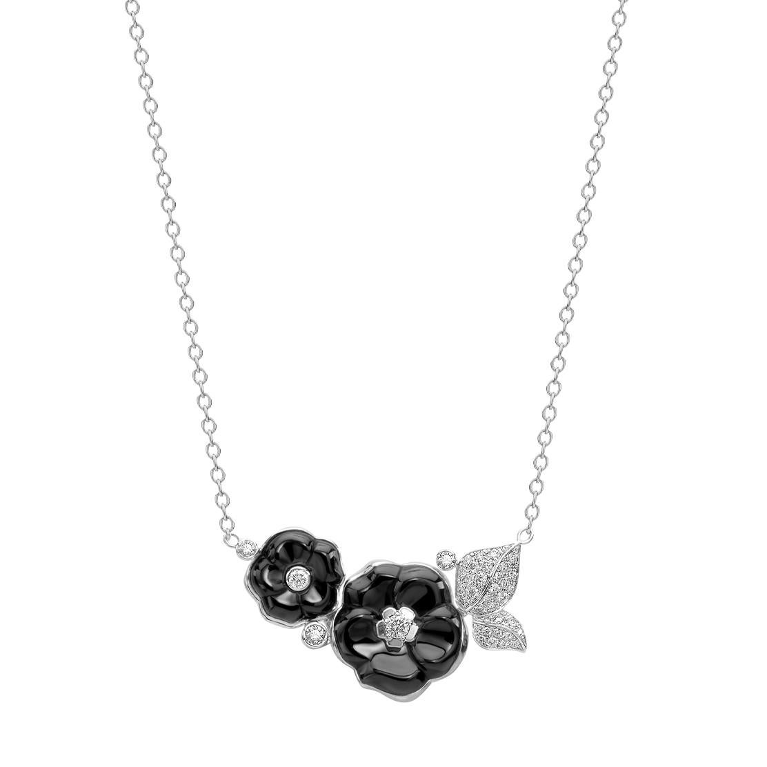 An iconic Chanel necklace from the Camellia collection showcasing 2 carved black ceramic flower motifs adorned with Chanel round brilliant cut diamonds in 18k white gold. The pendant measures 1.45