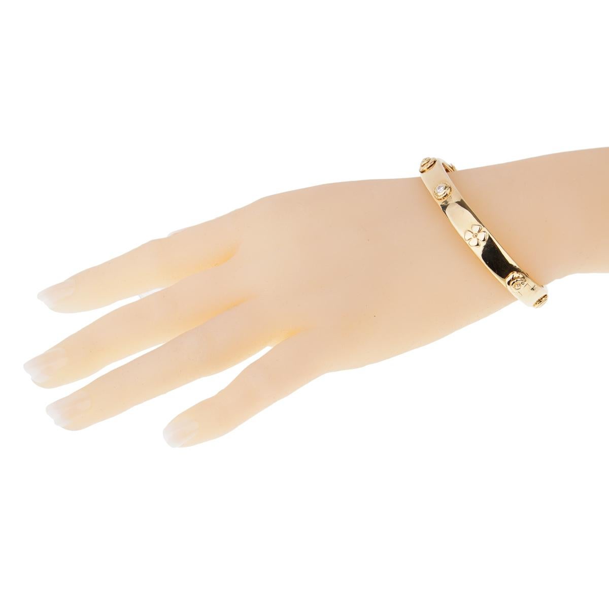 An exceptional 18K Chanel diamond yellow gold bangle bracelet. A part of the posh Chanel Caméllia collection, this marvelous bangle bracelet also features several of Chanel’s iconic Camellia flower icons.

