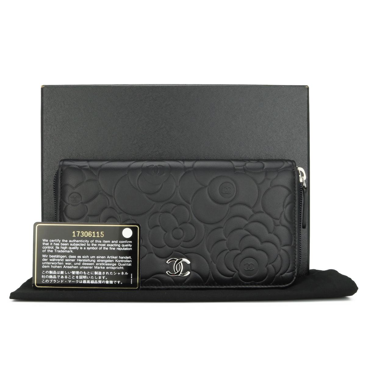 CHANEL Camellia Long Zipped Wallet in Black Lambskin with Silver Hardware 2013.

This stunning zip wallet is in never worn condition; the wallet still holds its original shape, and the hardware is still very shiny. It is such a gorgeous, functional,