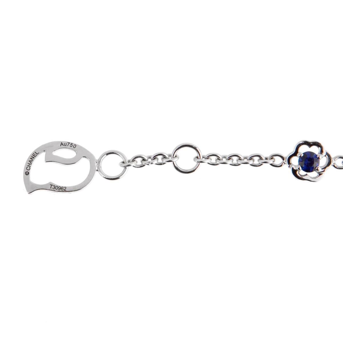 A fantastic Chanel bracelet featuring a Camellia flower set with blue sapphires, blue topaz and a round brilliant cut diamond followed by 2 delicate flowers set in 18k white gold.