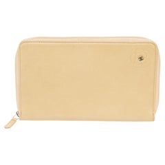 Chanel Camellia Zip Around Long Wallet features ivory leather body