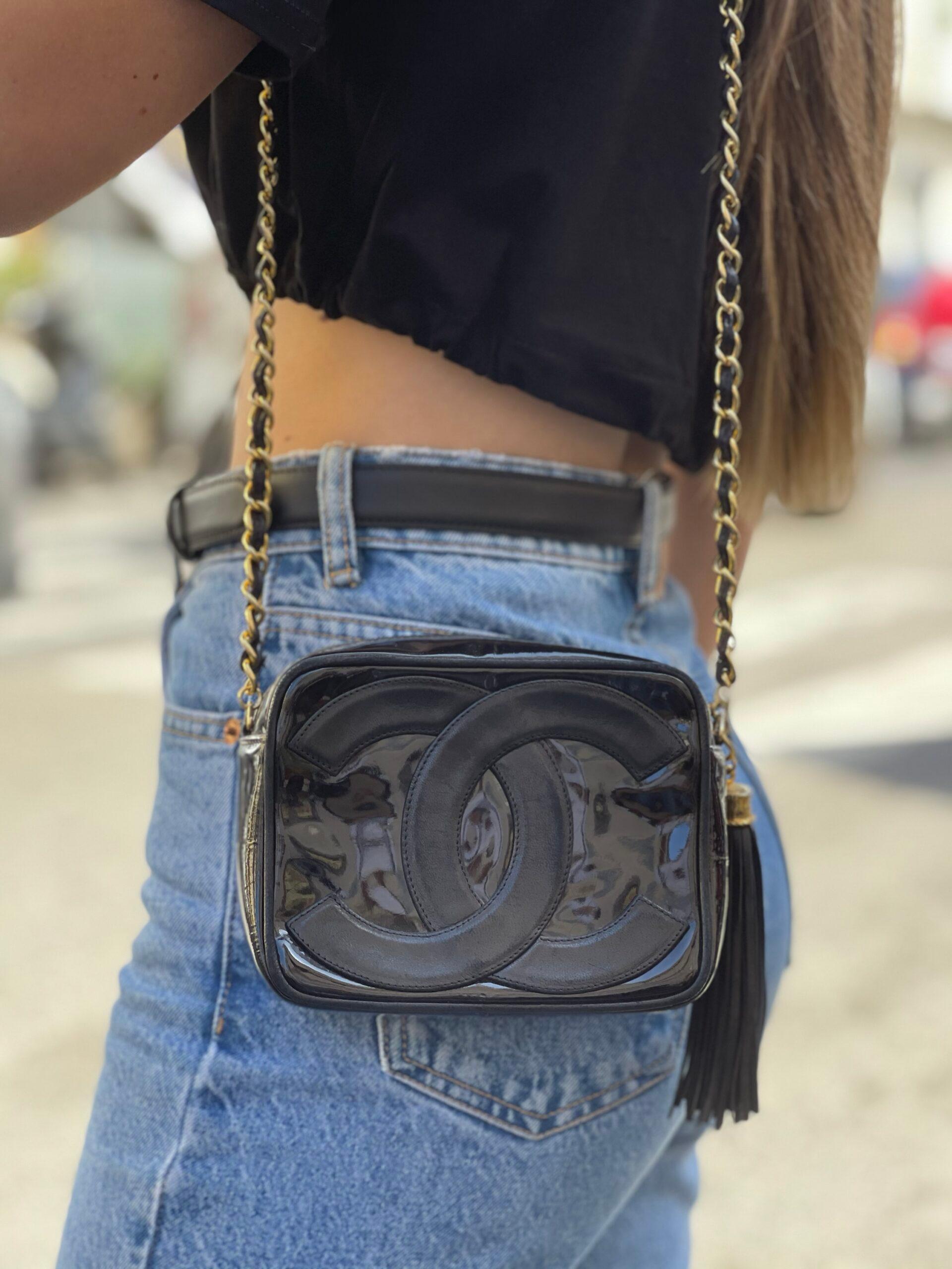 Vintage handbag by Chanel, Camera Bag model, made in black leather with black patent inserts and golden hardware. Equipped with a zip closure, internally lined in leather, roomy for the essentials. Equipped with a leather shoulder strap and braided