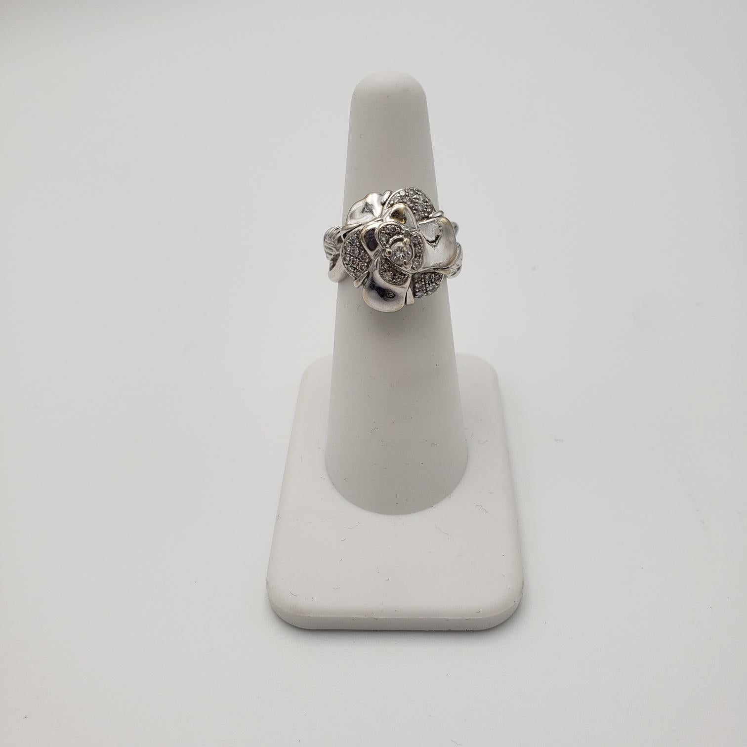 Authentic Chanel 'Camillia' flower ring crafted in 18 karat white gold and set with an estimated 0.40 carats of round brilliant cut diamonds. Signed Chanel, 91, 872, 750. Ring size 5 3/4. Not presented with original box or papers. CIRCA 2010s. 