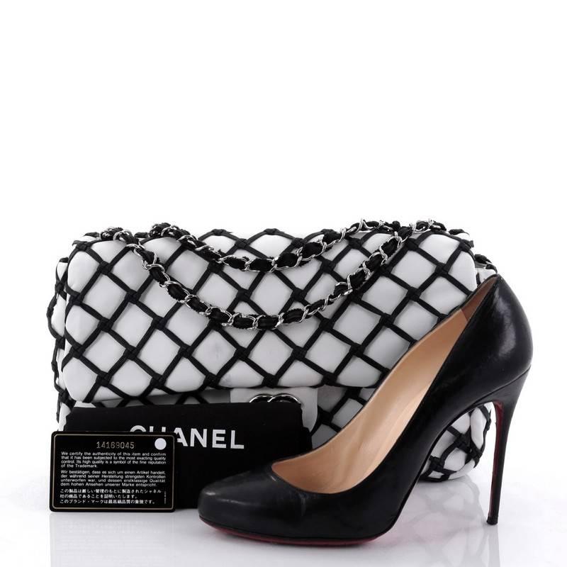 This authentic Chanel Canebiers Flap Bag Calfskin Jumbo from the brands' Cruise 2011 Collection is a luxurious bag that works day or night. Crafted from white calfskin leather with a unique netted overlay of black calfskin in the classic diamond
