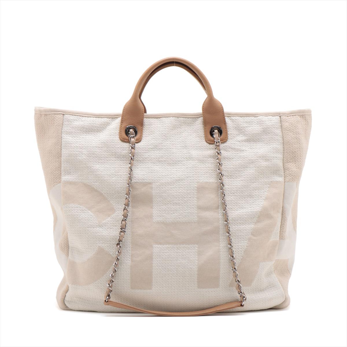 The Chanel Canvas Deauville Tote Bag in Light Beige is a chic and versatile accessory that effortlessly blends casual elegance with the iconic Chanel aesthetic. Crafted from durable canvas, the tote features oversized Chanel lettering all over the
