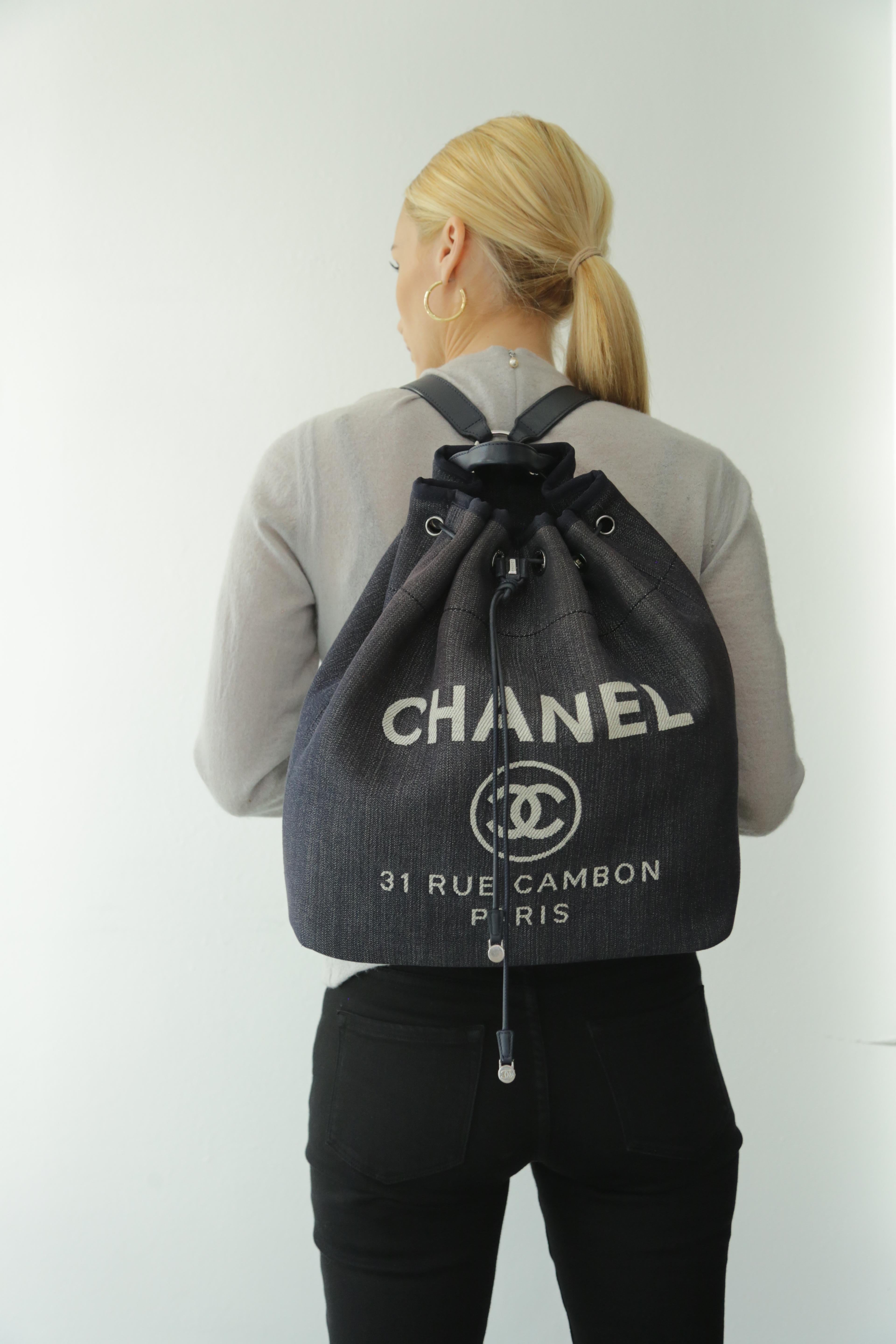 Chanel Canvas, Large Deauville Backpack in Denim Blue, 
Super hard to find style and fabric combo! Sold out everywhere. 
This lovely backpack is crafted of a fine blue denim canvas with a white stitched Chanel advertisement logo. The backpack