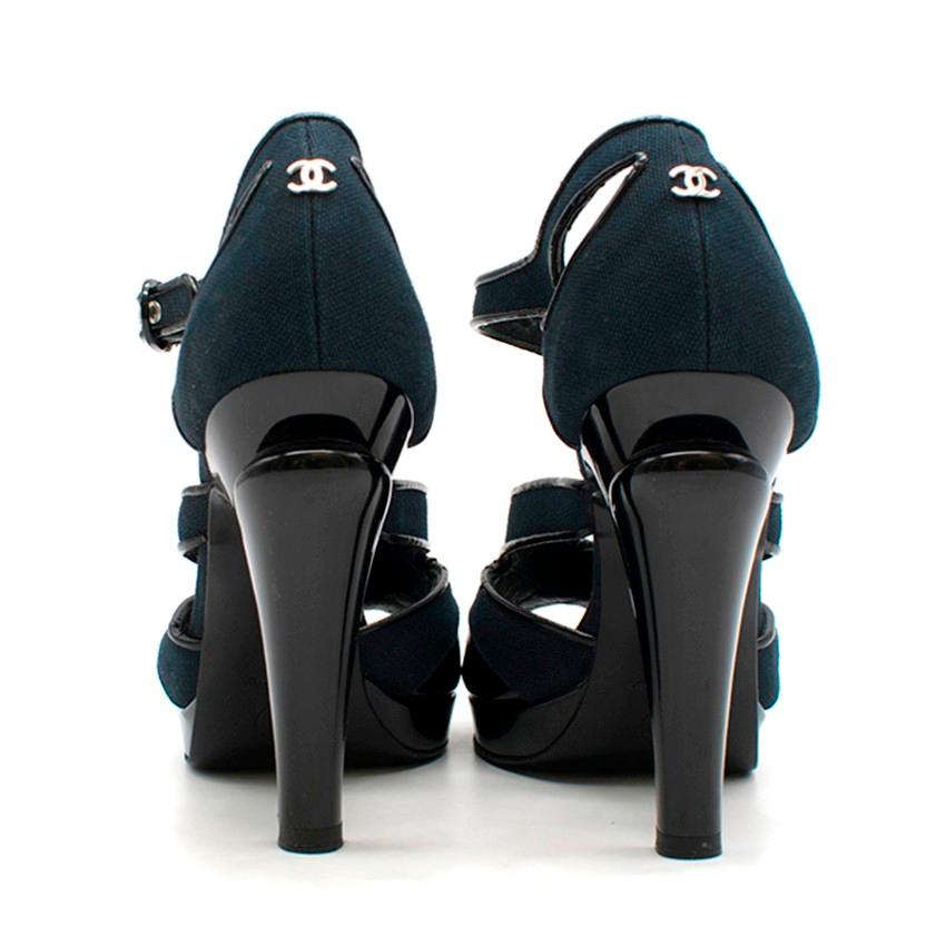 Chanel Canvas & Patent Leather Peep-Toe Cut-Out Sandals

- Black patent leather & navy canvas 
- Peep toe
- Cut-out detail
- Ankle strap fastening
- Silver-tone hardware
- CC on back of heel
- 1.5cm platform

Please note, these items are pre-owned