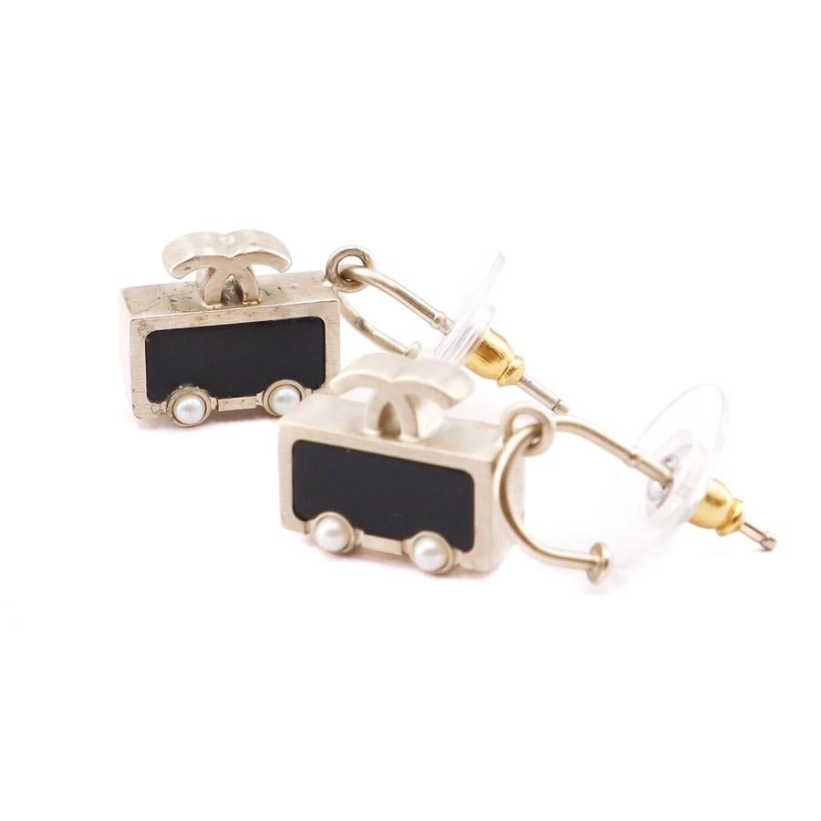 The earrings are studs from Maison CHANEL, each representing a small car in black enamel with beaded wheels on a gold metal base.
In a good condition. Two small beads (wheels) missing from a car (see photo). Otherwise we do not notice any particular
