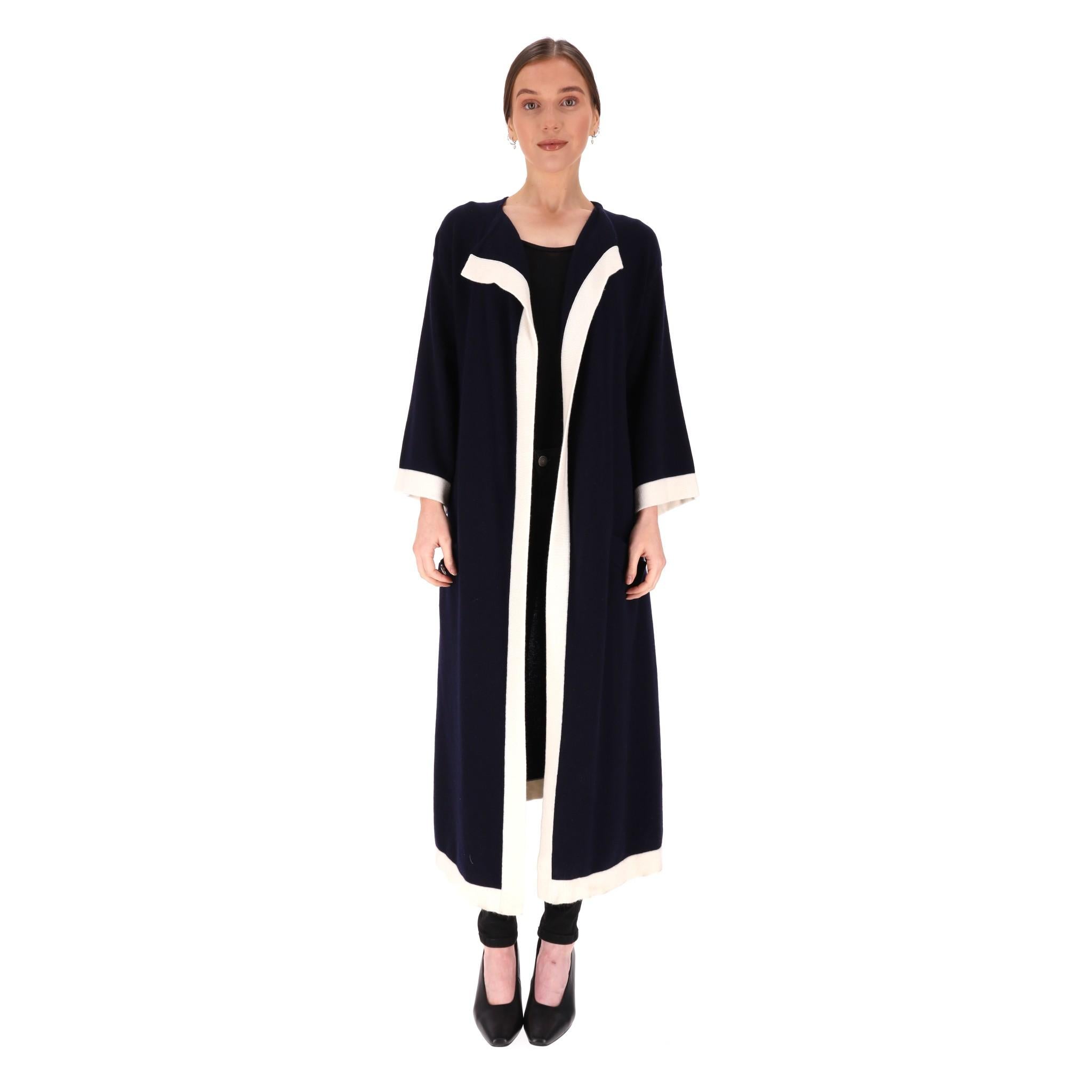 Chanel Cashmere Cardi/Coat With 'CC' Logo Buttons

From Fall 2016 Collection by Karl Lagerfeld is this navy cardigan with contrasting white trims.

Detailed with silver, 'CC' logo embossed buttons to the front pockets.

Wide, three-quarter sleeves