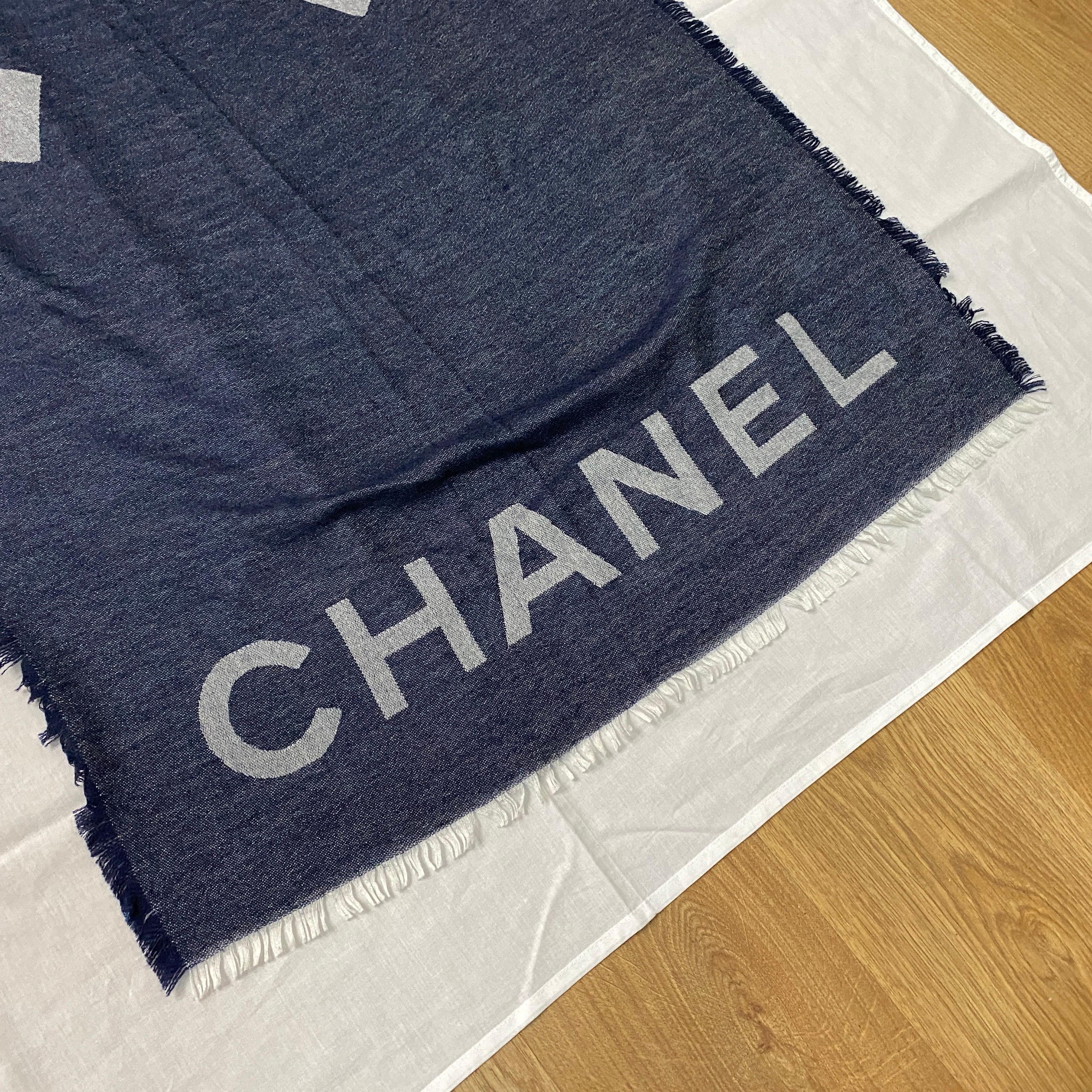 A Chanel cashmere and silk scarf, blue and gray, CC logo print on the front. 