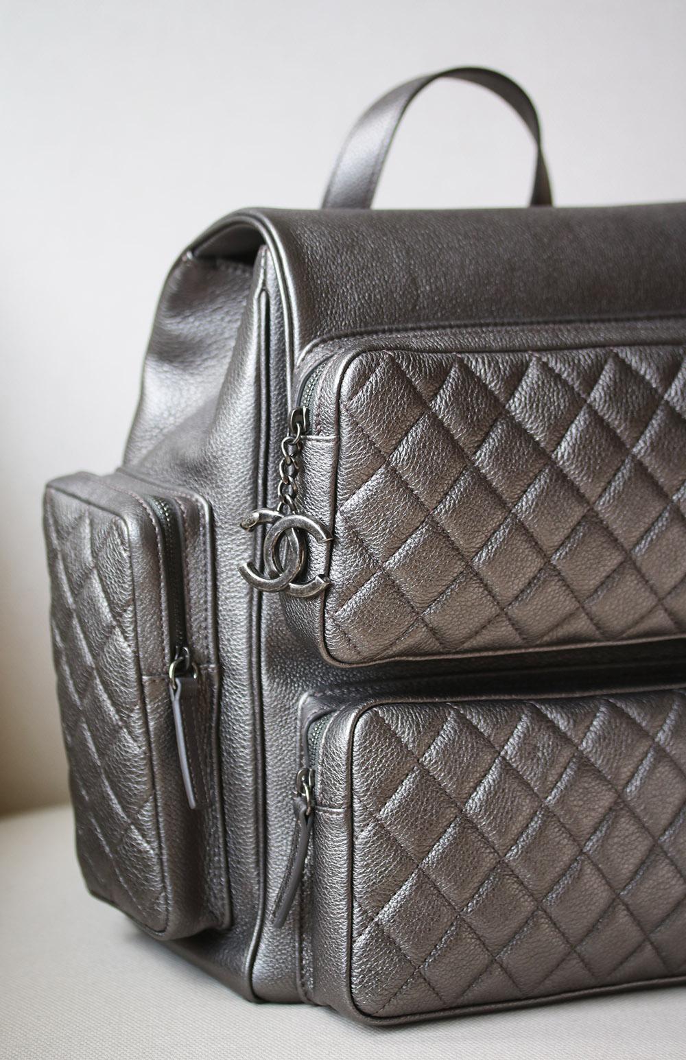 Chanel metallic Casual Rock grained calfskin quilted large backpack in charcoal. This stylish backpack is crafted of glazed calfskin leather in a metallic dark charcoal silver. This squared bag features structured diamond quilted front external