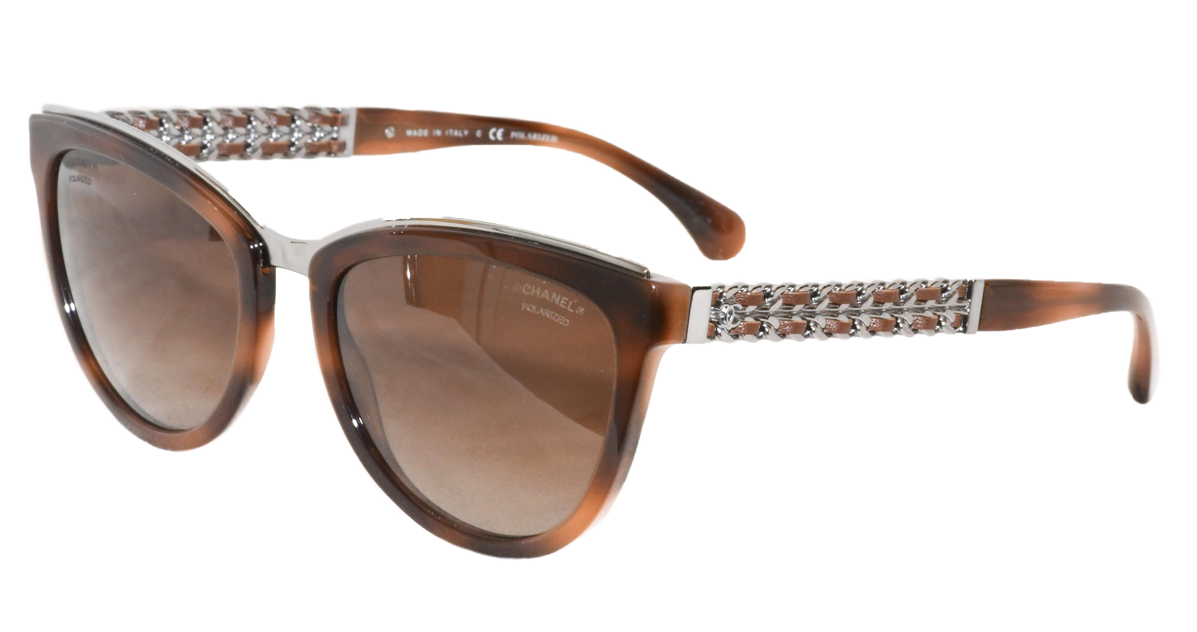 Chanel.  Not much else needs to be said.  These fabulous brand new, never worn cat eye sunglasses are perfection Chanel.  Temple arms sport iconic CC logo and braided chain detail.  Polarized lenses.  Hallmarked 5361-0 Made in Italy.  Warm brown