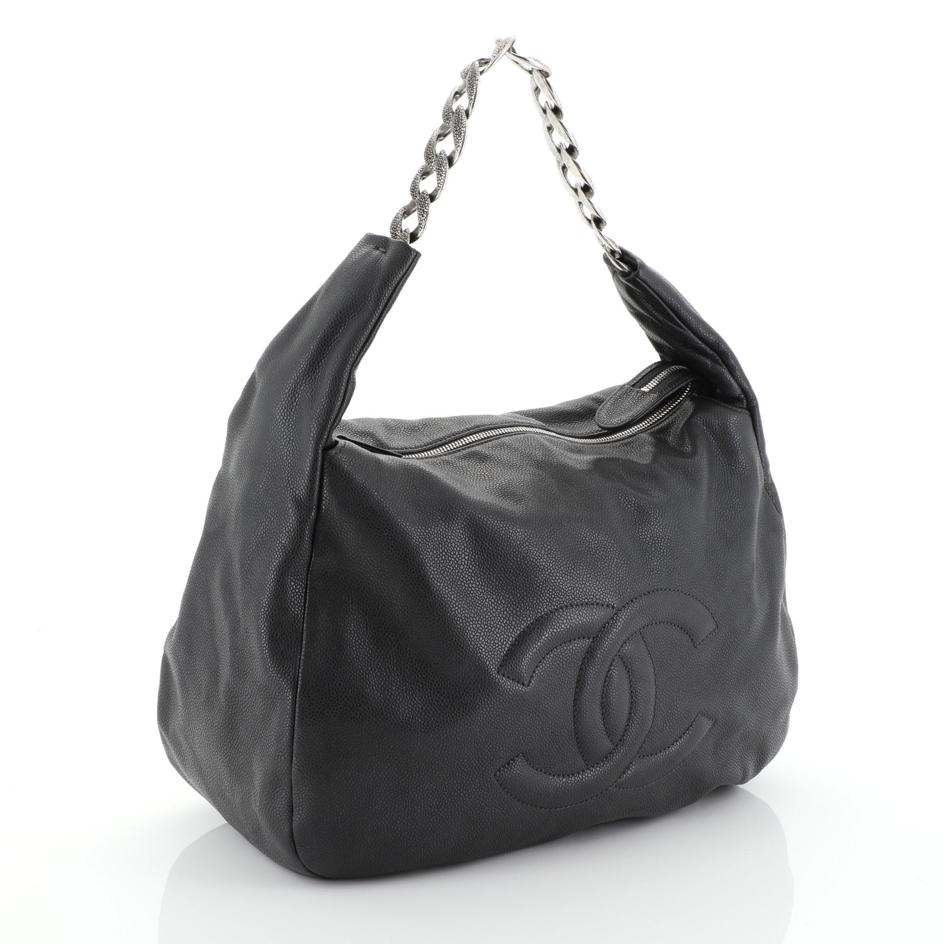 This Chanel Caviar 31 Hobo Caviar, crafted in black caviar leather, features an oversized CC logo stitched at the front, gigantic aged silver textured chain links and aged silver-tone hardware. Its top zip closure opens to a black fabric interior