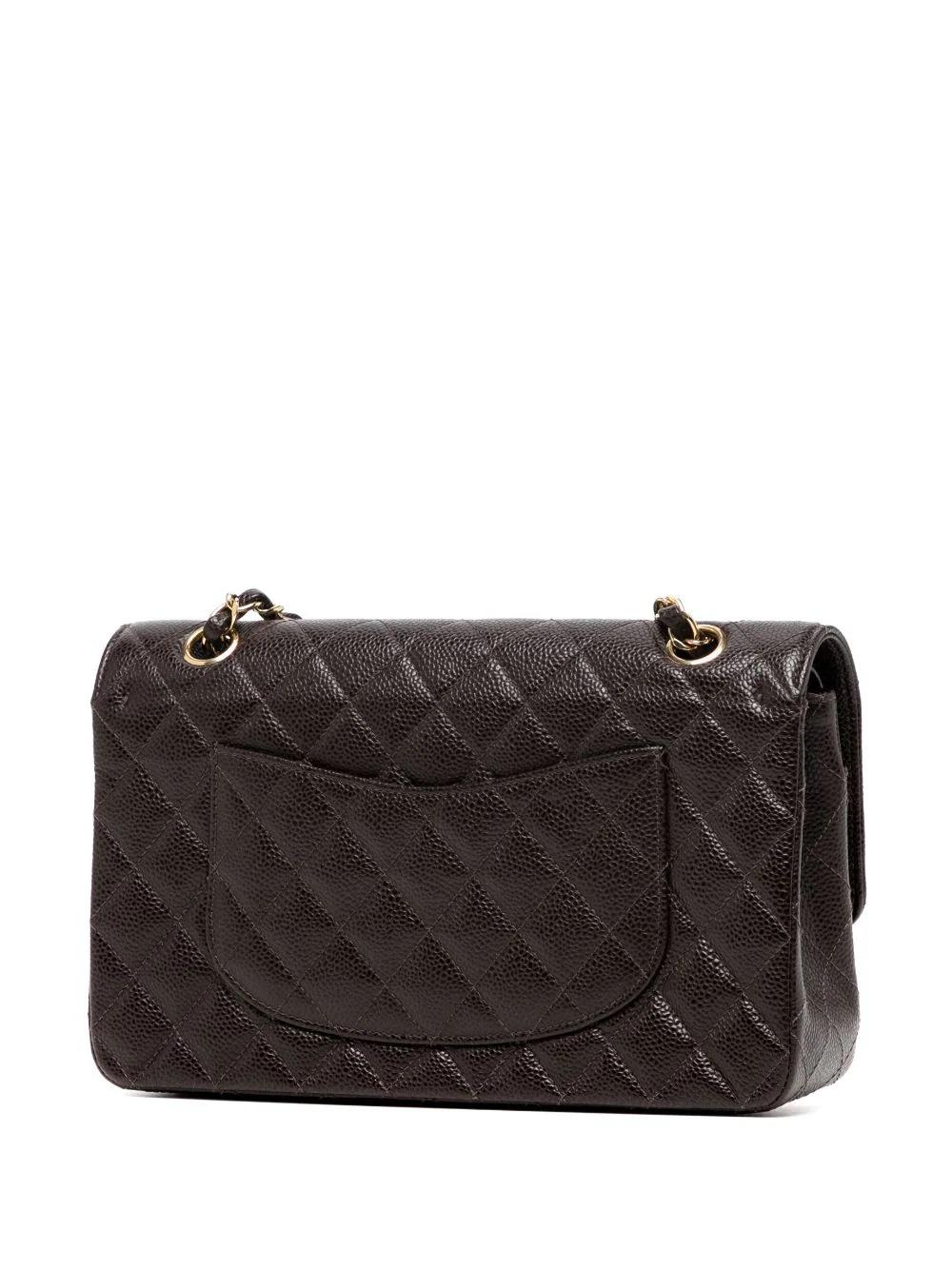 A timeless design from the Maison, CHANEL’s Double Flap shoulder bag is considered the pinnacle of sophistication. This iteration is handcrafted from diamond-quilted rare brown caviar leather and finished with refined gold-tone hardware.

* Coffee