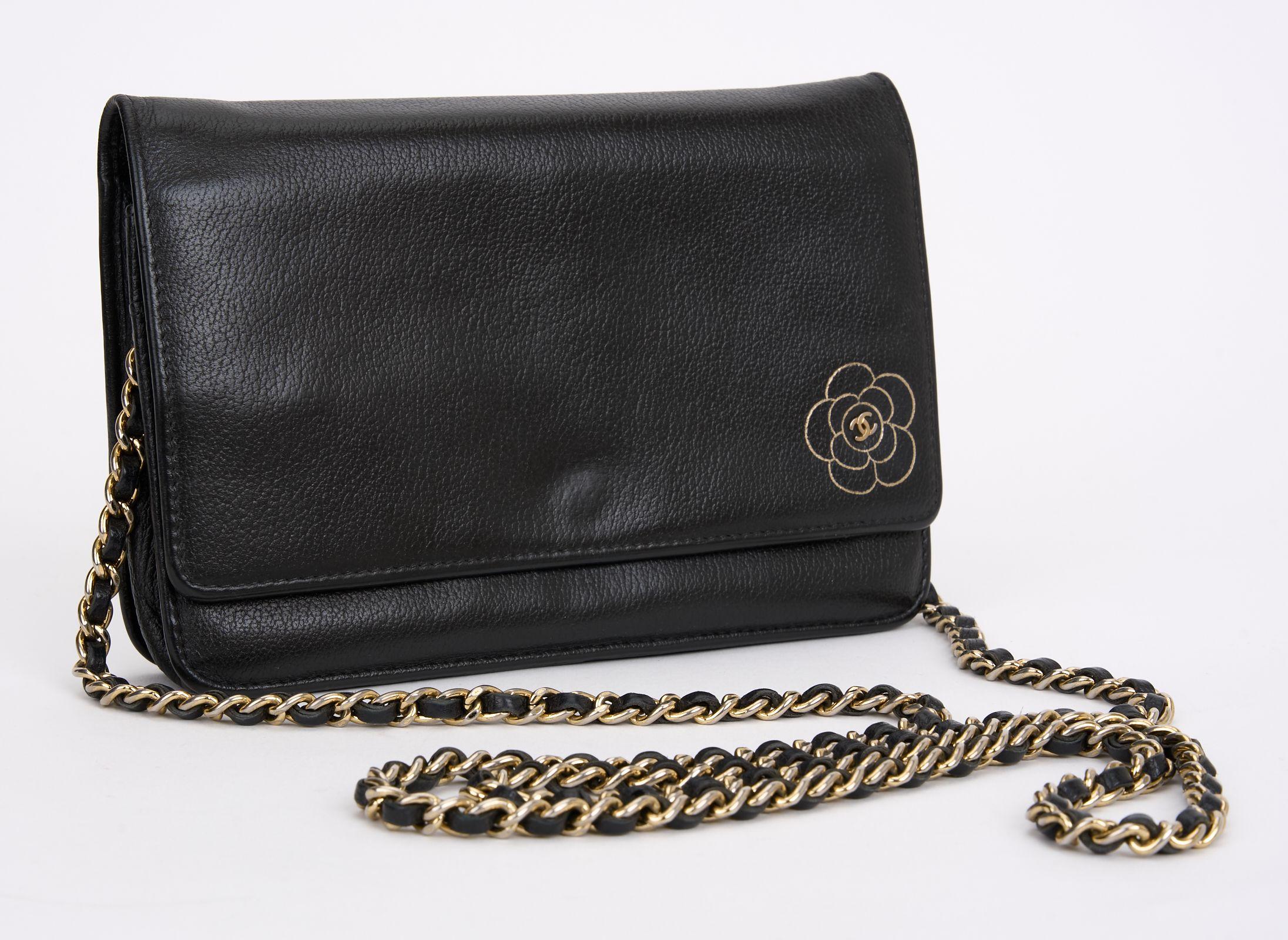 This Chanel Caviar Camellia Wallet on Chain Gold-tone hardware features black leather with CC flower logo at the front, a single chain-link and leather shoulder strap, leather under flap, black fabric lining, a single zip pocket at the front flap,