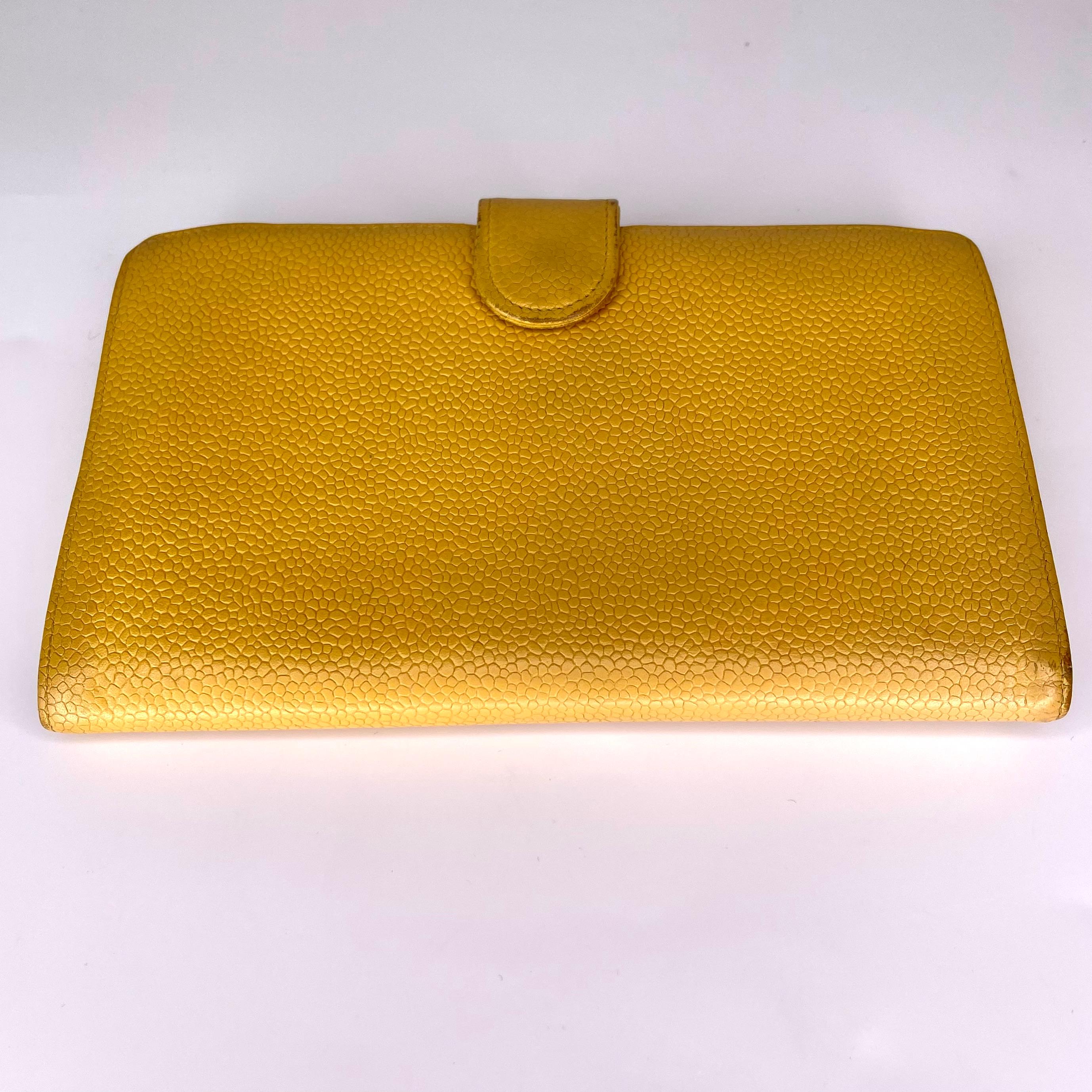 Chanel leather wallet with six interior card holders and one pocket to hold a variety of different items. Compact and easy to use. Chanel codes starting with 5xxxxxx are manufactured from 1997-1999.

COLOR: Mustard yellow 
MATERIAL: Caviar