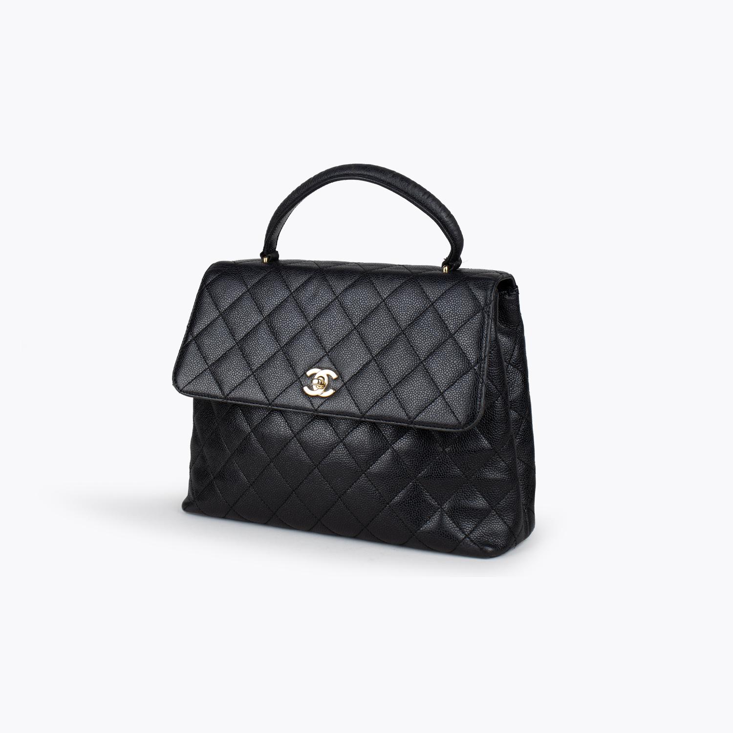 Black quilted caviar leather Chanel Kelly bag with

- Gold-tone hardware
- Single semi-rolled top handle
- Tonal leather lining
- Dual interior pockets; one with zip closure and signature CC turn-lock closure at front flap
- Dual interior