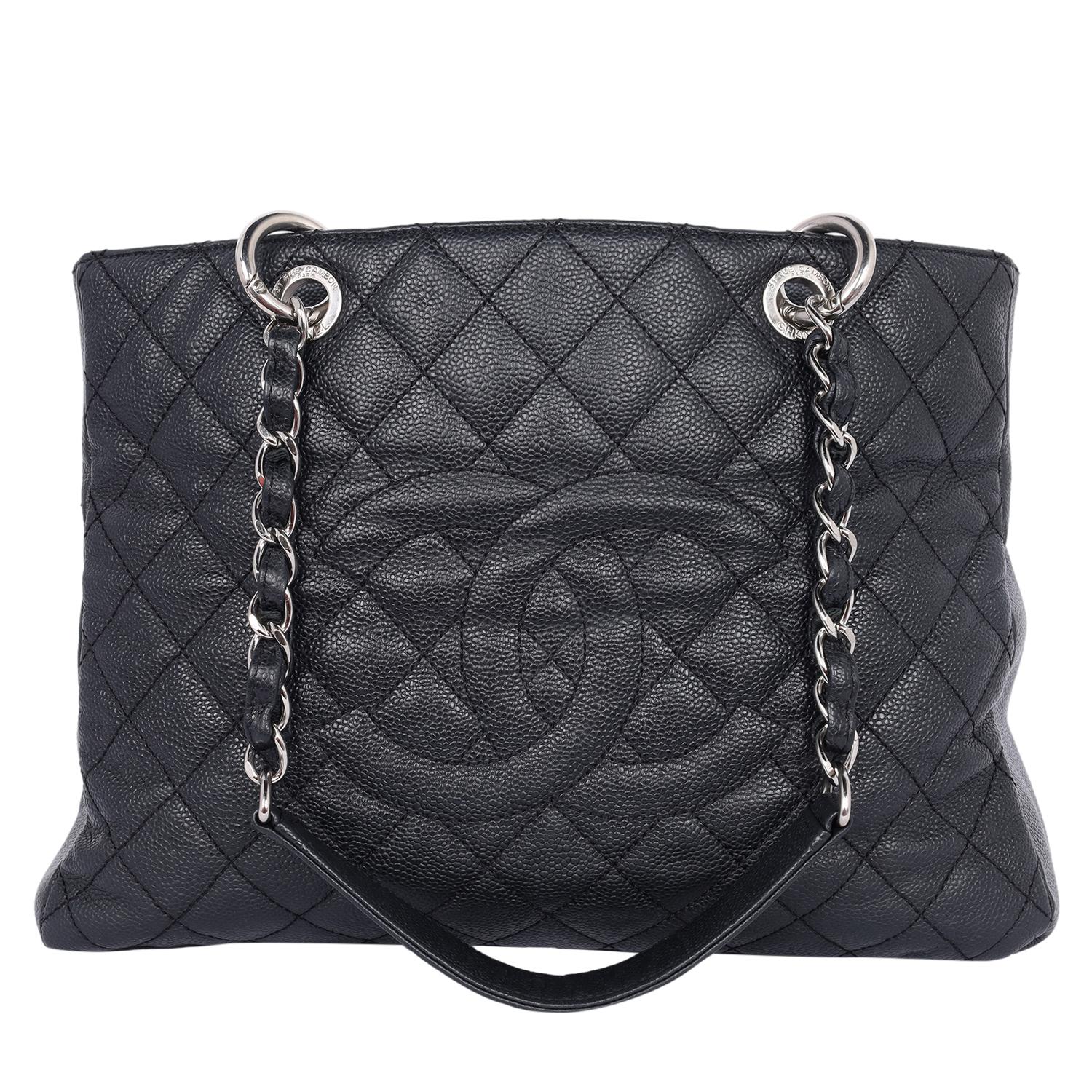 Authentic, pre-loved Chanel Caviar Quilted Grand Shopping Tote GST in Black. This amazing tote features a black diamond quilted caviar leather, Chanel CC logo on the front, and a flat pocket on the rear. The top opens to a zipper middle pocket with