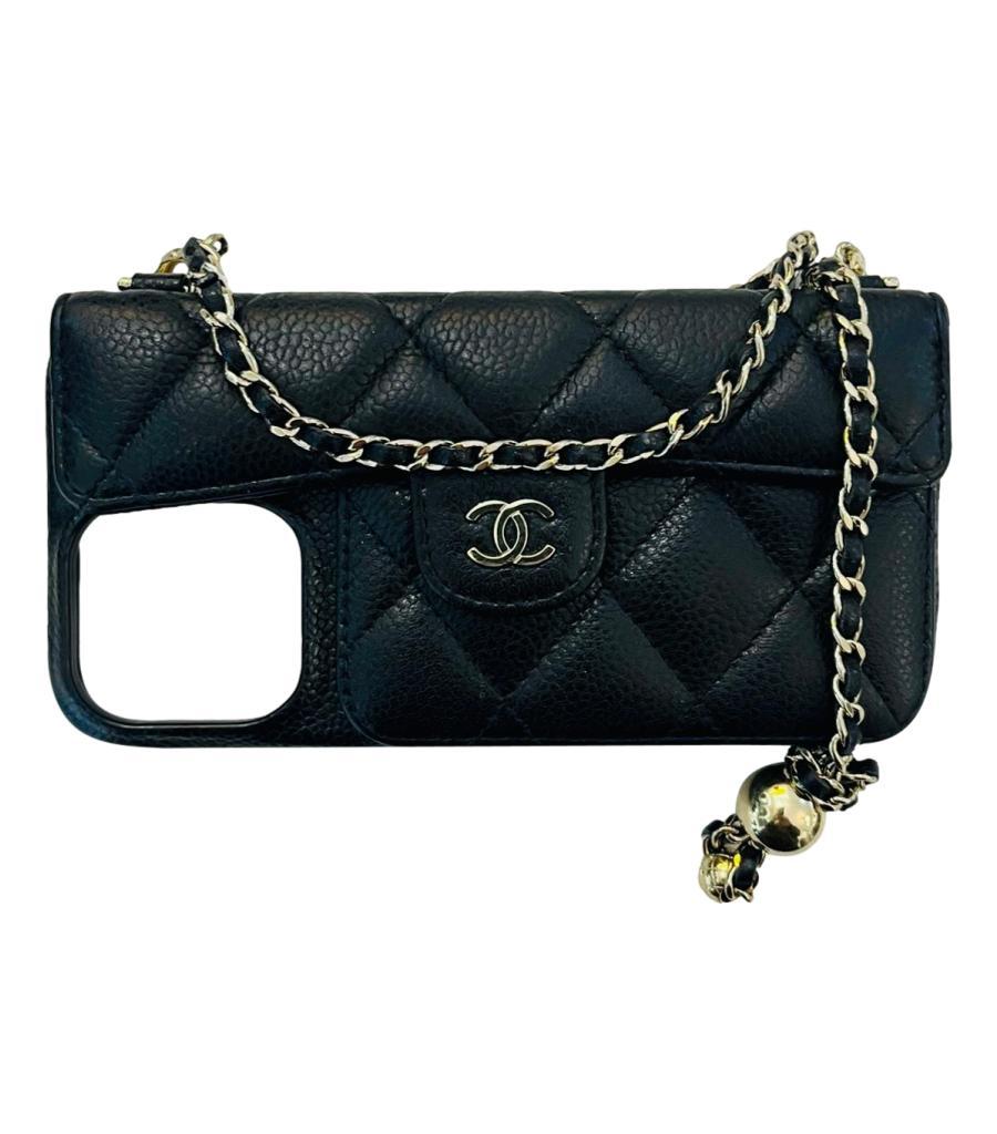 Chanel Caviar Leather iPhone Case On Chain

Black phone case crafted in caviar lambskin leather, designed with gold 'CC' logo snap closure leading to card slot.

Featuring adjustable leather and chain hand/shoulder strap detailed with gold 'CC' logo