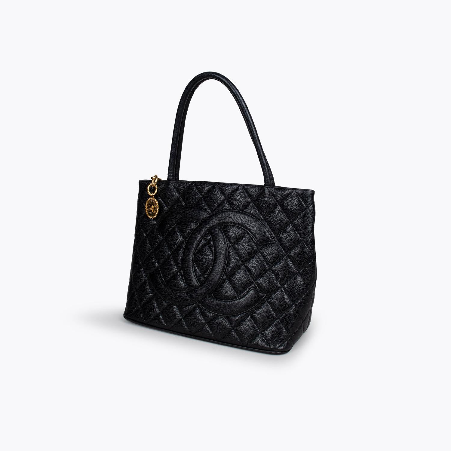 Black quilted Caviar leather Chanel Medallion tote with

- Gold-tone hardware
- Dual rolled shoulder straps
- Patch pocket at exterior back
- Tonal leather interior, dual pockets at interior wall; one with zip closure and zip closure at top