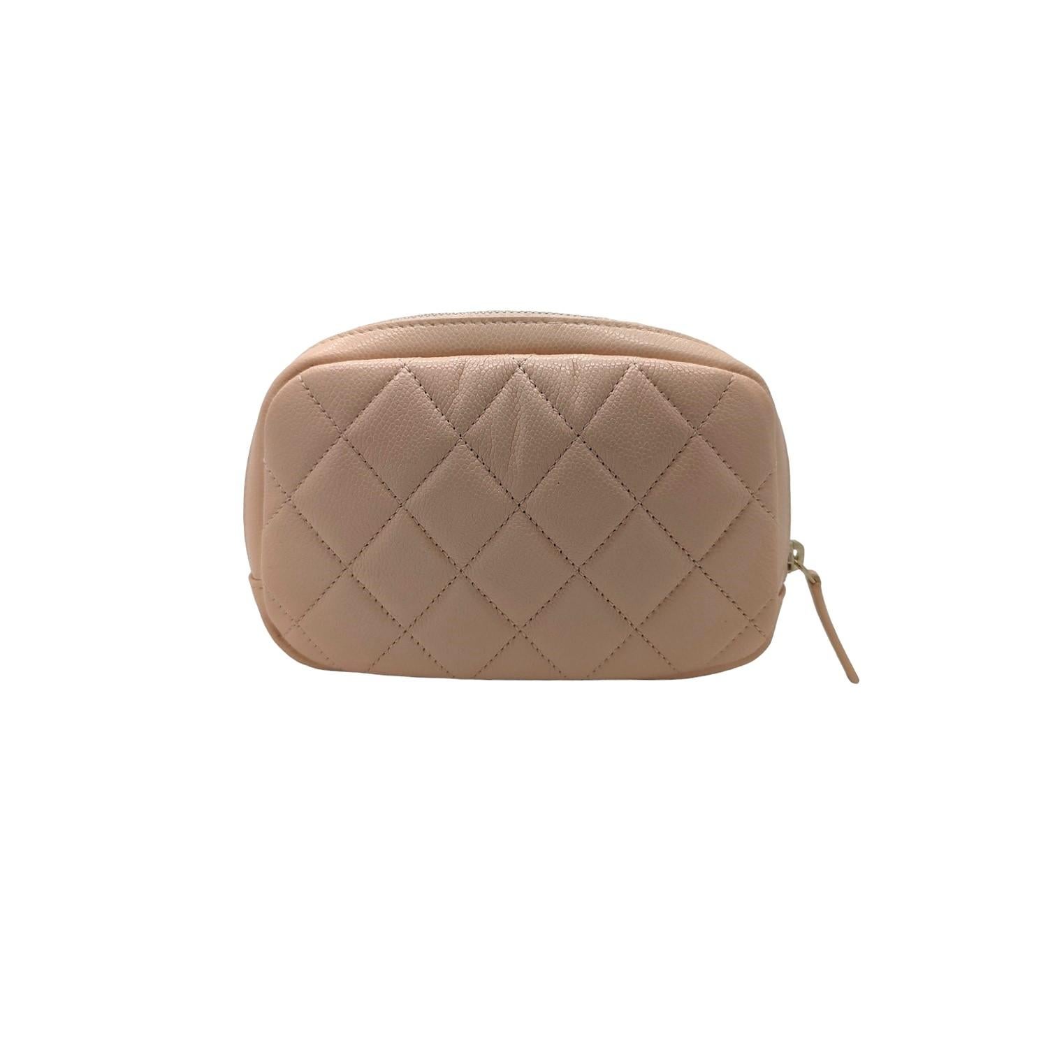 From the 2021-2022 Collection by Virginie Viard; Chanel Caviar Quilted Small Curvy Pouch Cosmetic Case. This small sized cosmetics case is crafted of caviar quilted leather in light beige (with a peach undertone). Featuring a polished gold Chanel CC