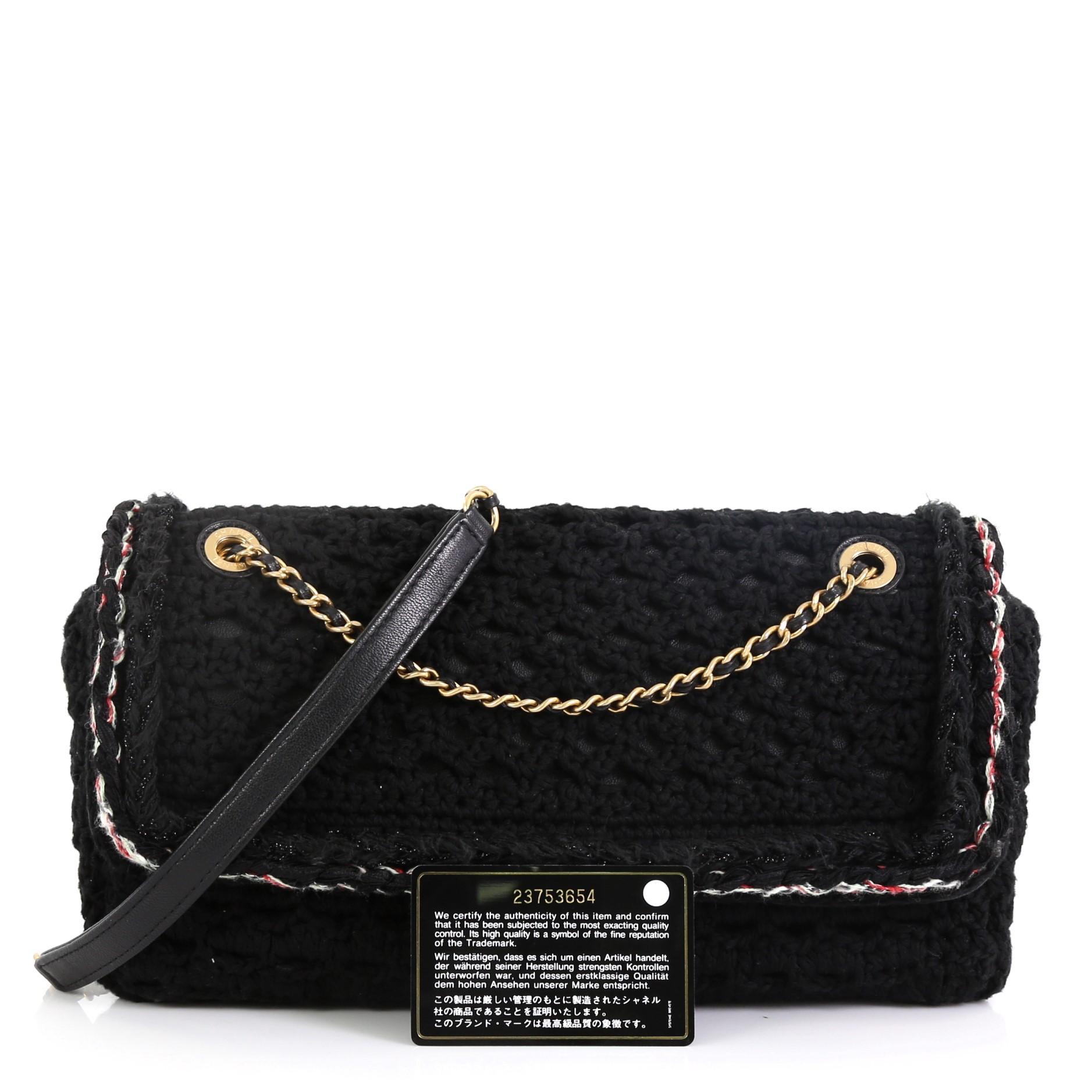 This Chanel Cayo Coco Flap Bag Crochet Medium, crafted in black crochet fabric, features woven-in leather chain strap and gold-tone hardware. Its CC turn-lock closure opens to a black fabric interior with zip pocket. Hologram sticker reads: 23753654