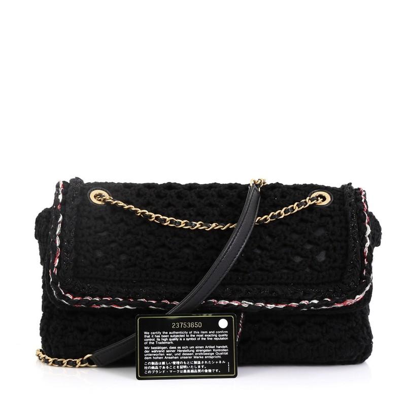 This Chanel Cayo Coco Flap Bag Crochet Medium, crafted in black crochet, features woven-in leather chain strap, front flap with CC turn-lock closure and aged gold-tone hardware. Its turn-lock closure opens to a black fabric interior with zip pocket.