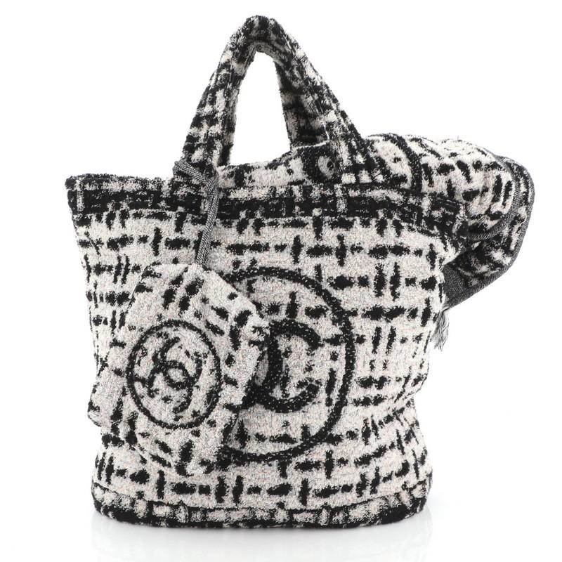 This Chanel CC Beach Tote Terry Cloth Large, crafted from black and multicolor terry cloth, features CC printed design and dual top handles. It opens to a grey fabric interior. 

Estimated Retail Price: $1,700
Condition: Excellent. Minimal fraying