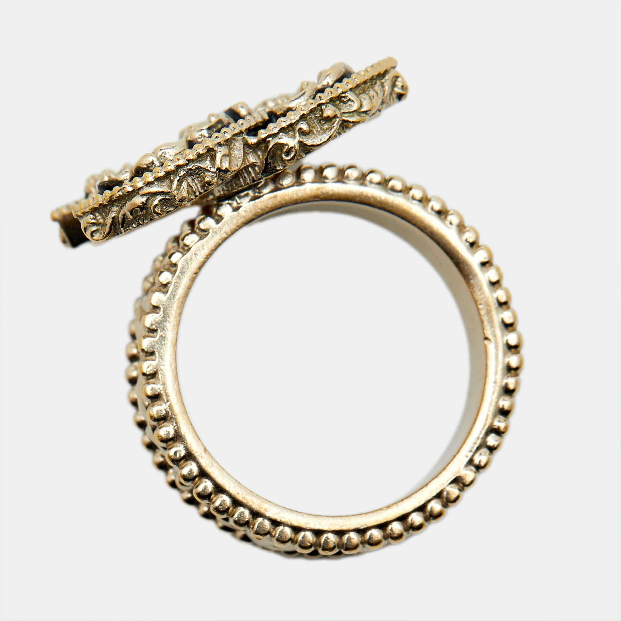 This cocktail ring by Chanel is crafted from gold-tone metal and features exquisite textures. The iconic CC logo rests at the heart of this beautiful design. The ring is complete with hallmark engravings on the inside of the band.

