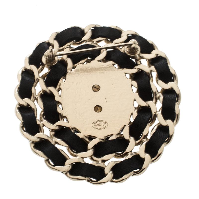 We are loving this gorgeous brooch from Chanel! It comes in a round shape with the CC logo surrounded by chains interlaced with black leather. Complete with a pin closure at the back, this brooch will make a great buy.

Includes: Original Box, Price