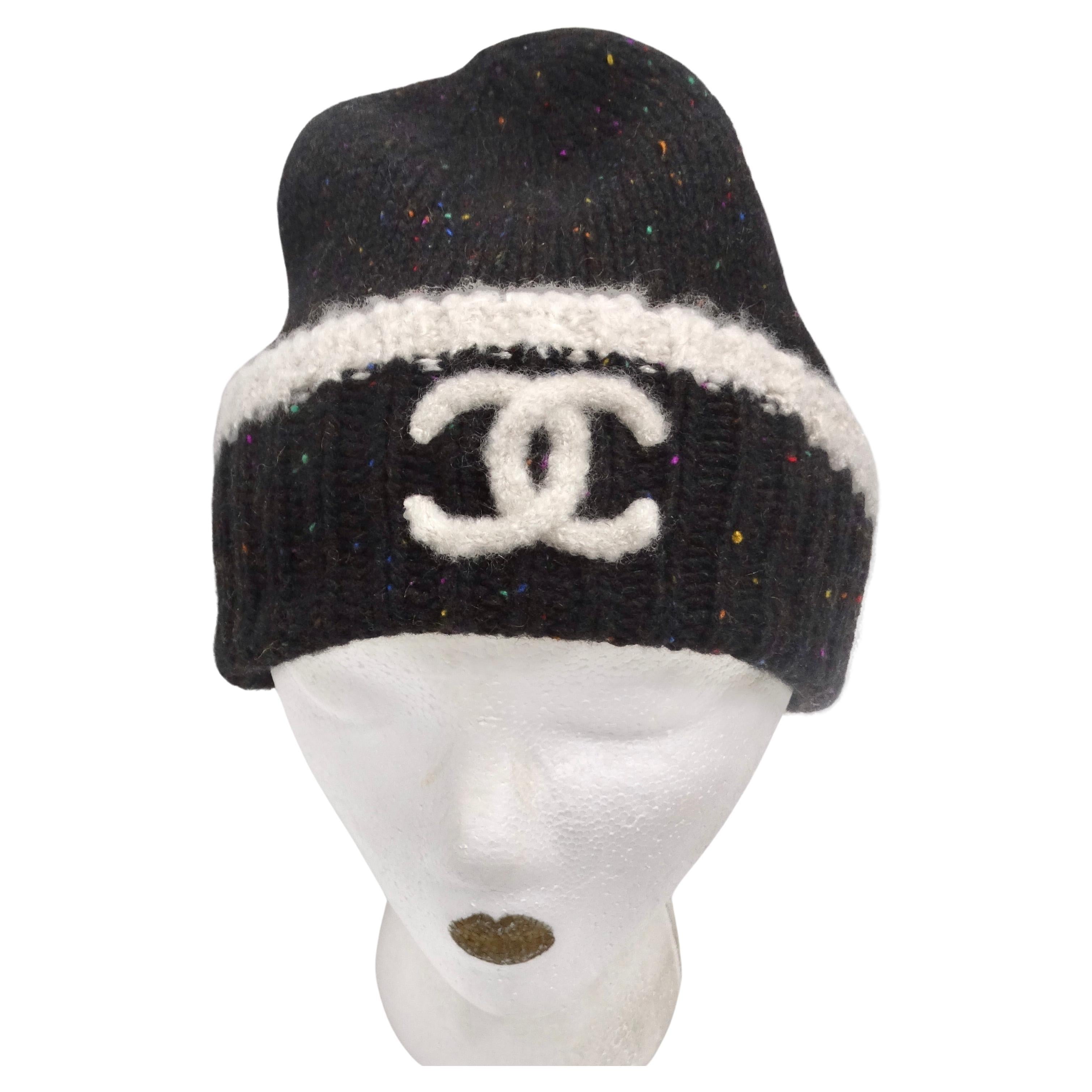 Introducing the Chanel CC Black Rainbow Specks Cashmere Beanie Hat – a perfect blend of luxury, style, and comfort. This black knit beanie is not just an accessory; it's a statement piece that embodies the unmistakable Chanel flair. Elevate your