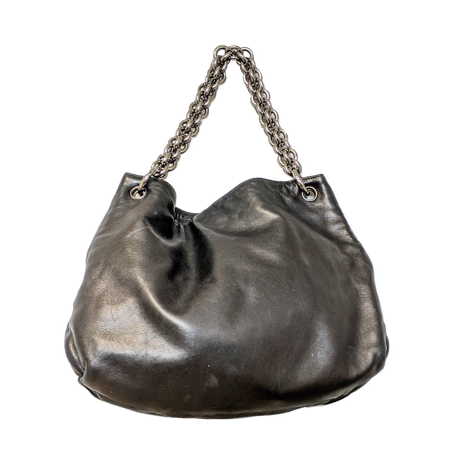 Black leather Chanel Soft & Chain hobo with ruthenium-tone hardware, single chain-link top handle, embroidered CC embellishment at front face, tonal satin lining, three pockets at interior walls; one with zip closure and magnetic snap closure at