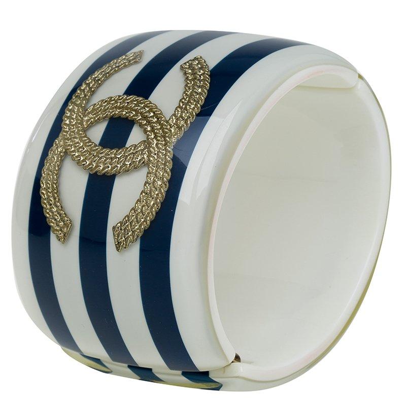 This stylish bracelet has prominent Chanel stamp. Made from resin with blue and white stripes, this bracelet is accented with gold-tone CC logo crest.

Includes: The Luxury Closet Packaging


