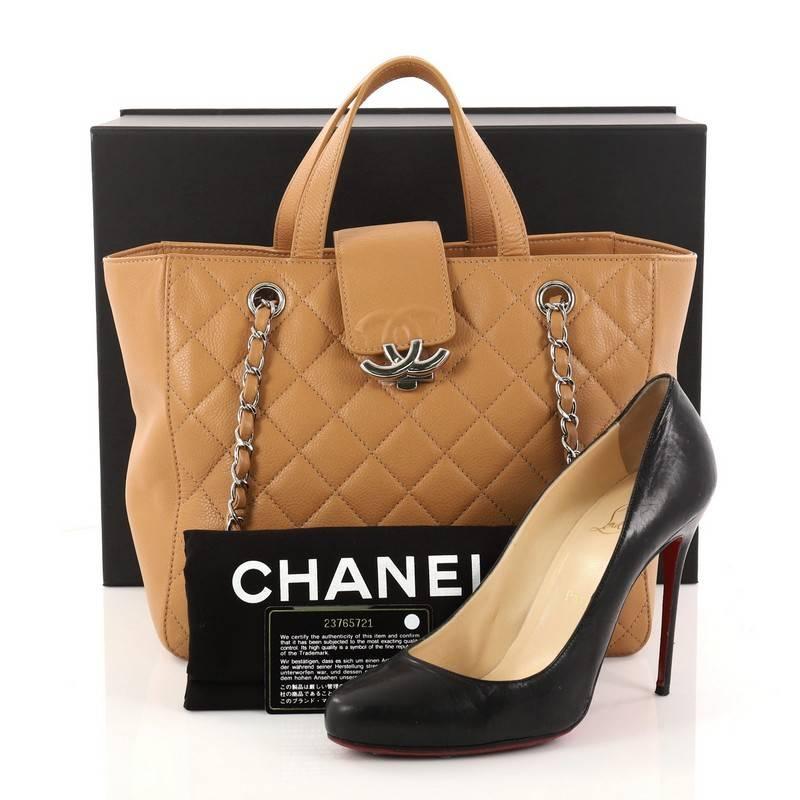 This authentic Chanel CC Box Shopping Tote Quilted Caviar Small is an excellent tote for day wear and shopping excursions. Crafted in camel quilted caviar, this stylish tote features dual-flat leather handles, dual woven-in leather chain straps with