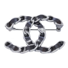 Chanel CC brooch in silver metal and interwoven leather effect