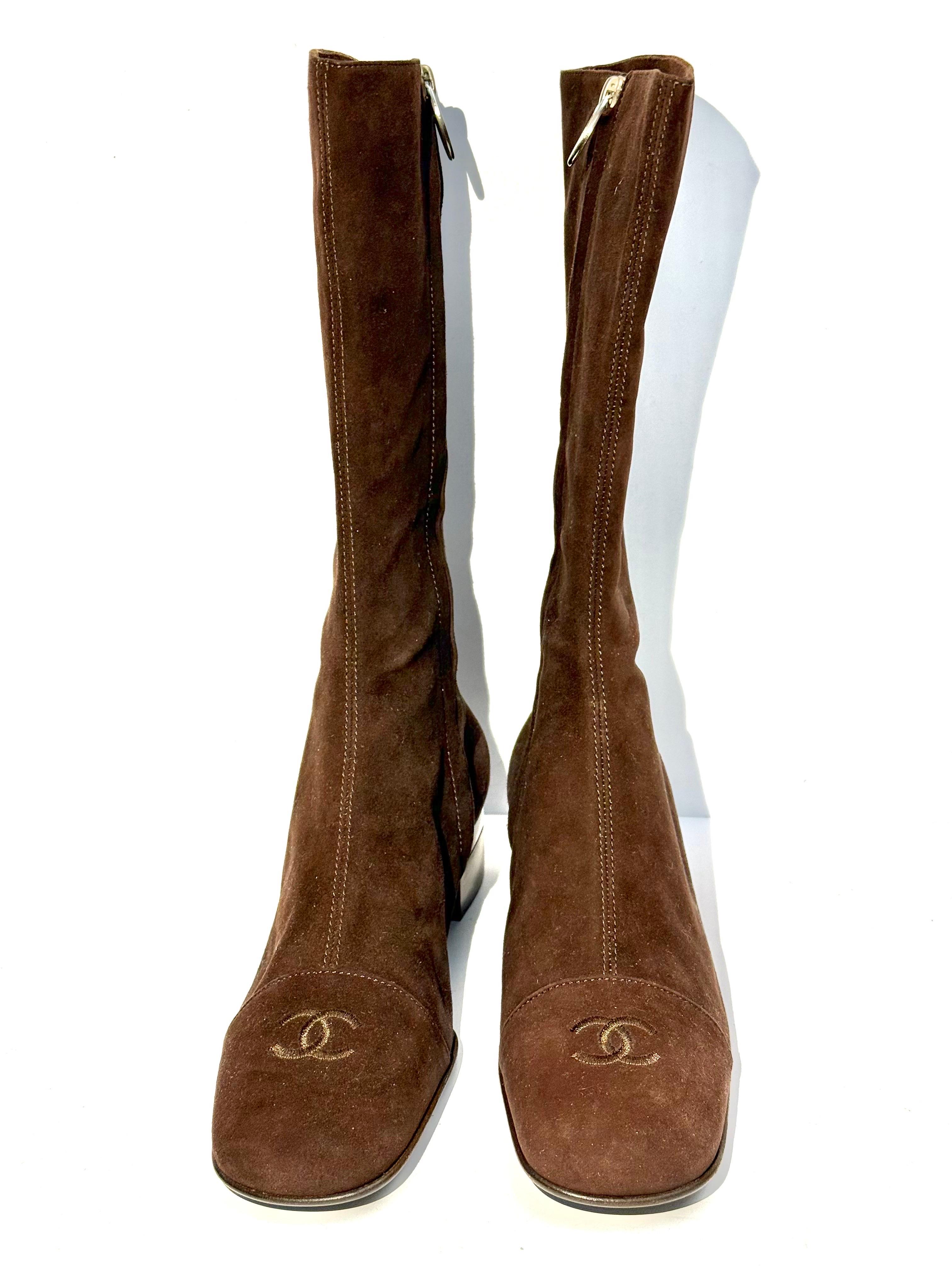 - Vintage Chanel brown suede logo boots. Almost new condition. 

- Embossed CC logo. 

- Silver toned hardware CC side zip closure. 

- Silver toned hardware and brown wood sole with 