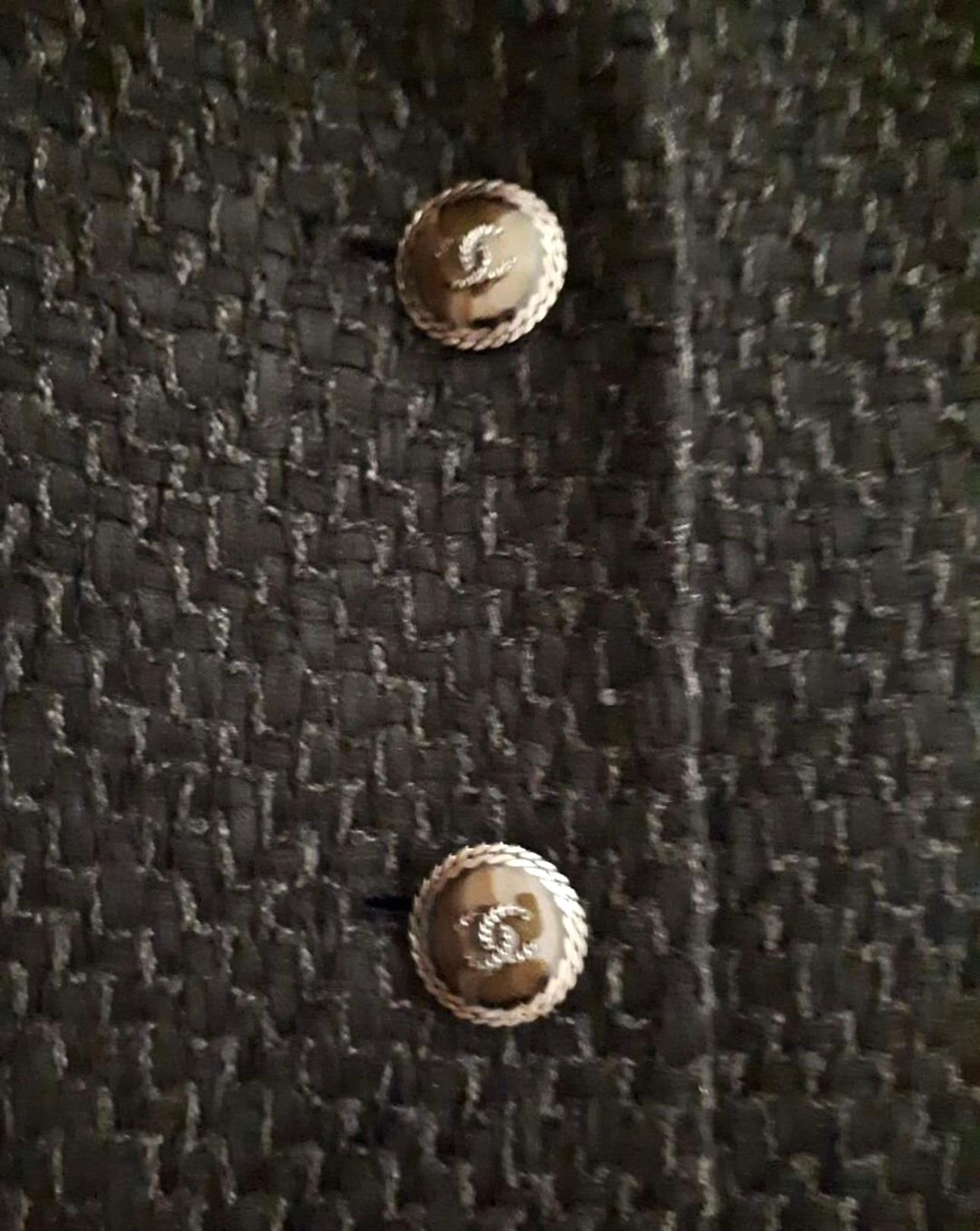 Timeless Chanel black tweed cocktail dress with CC buttons.
Charming ruffled skirt part, tonal silk lining.
Size mark 40 FR. Never worn.