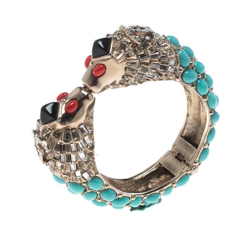 This marvellously designed cuff bracelet by Chanel is so pretty you'll love having it on your wrist. The gold-tone metal creation has been designed with lion heads and an array of crystal baguettes and faux cabochon. It will look great with your