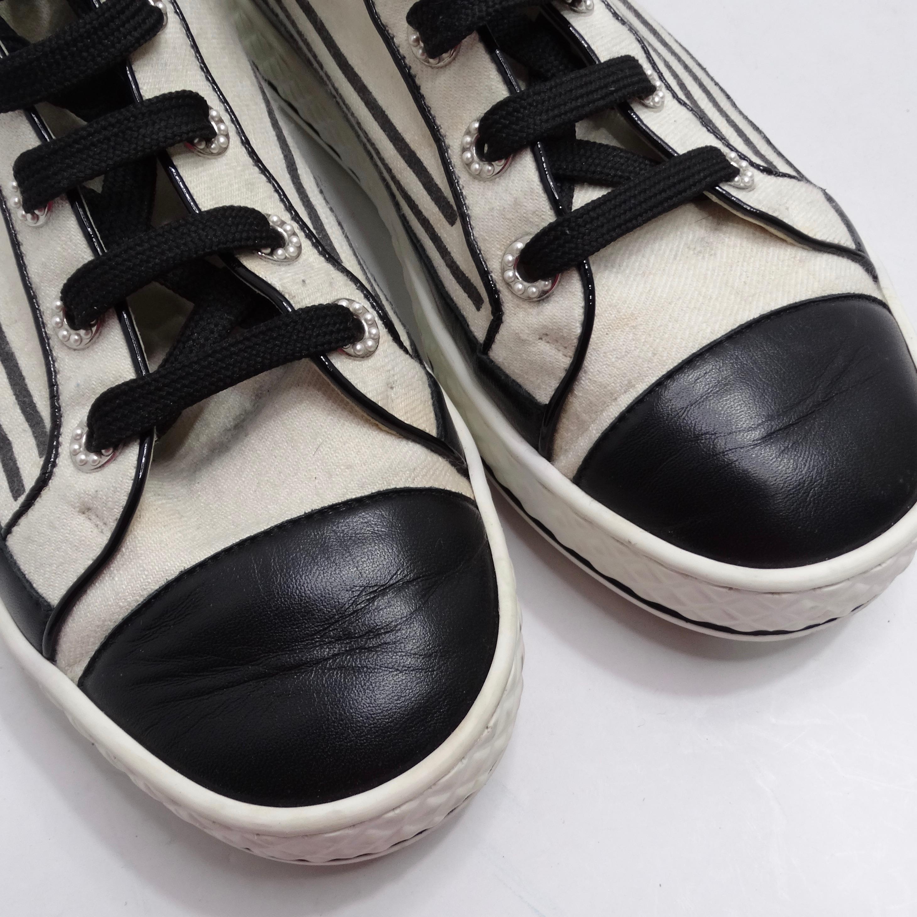 Get your hands on the Chanel CC Canvas High Top Sneakers—an exquisite pair that seamlessly fuses everyday comfort with the unmistakable elegance of Chanel. These high-top sneakers aren't just footwear; they're a wearable canvas of luxury and iconic